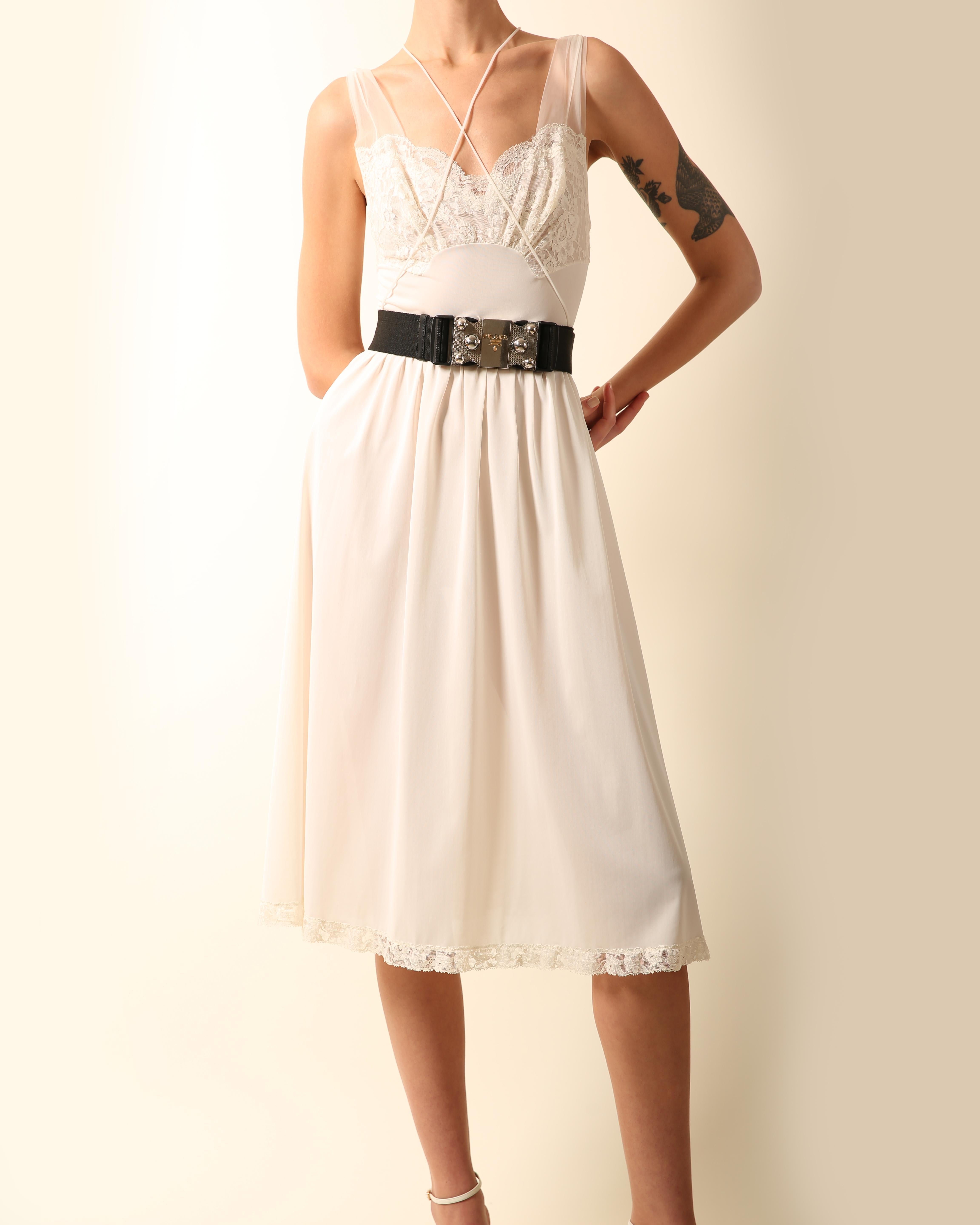 A very pretty vintage ivory dress with lace bust and sheer mesh straps
Cinched in waist
Attached straps that cross over the body
Lace trim hem
Belt not included 

Composition:
No composition label but estimated to be stretch nylon

Size:
No size