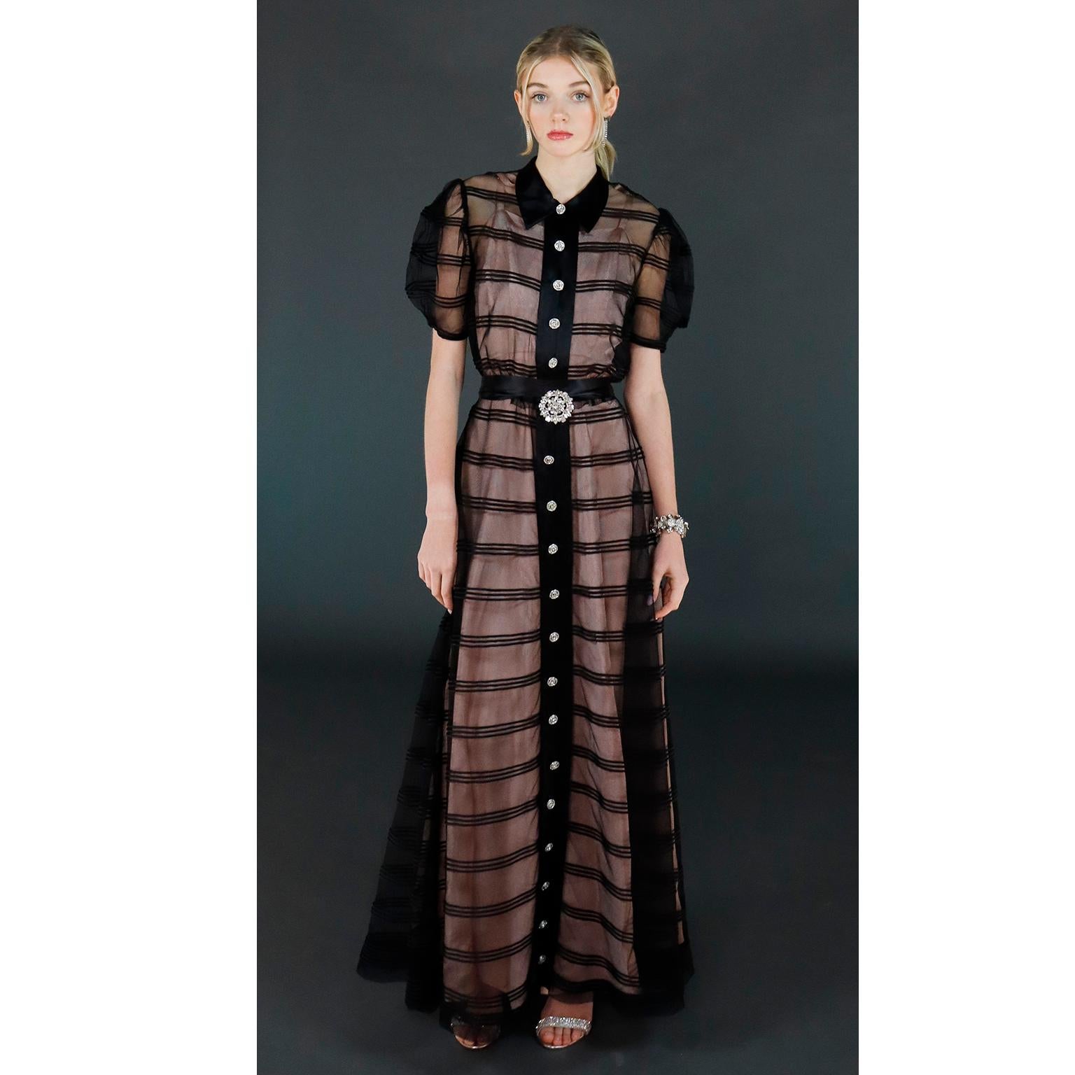 This gorgeous vintage dress was designed back in the late 1930's or early 1940's and is reminiscent of many couture fashion house dresses created in the 2000's and 2010's! The dress has short puff sleeves and horizontal lines over a sheer black net