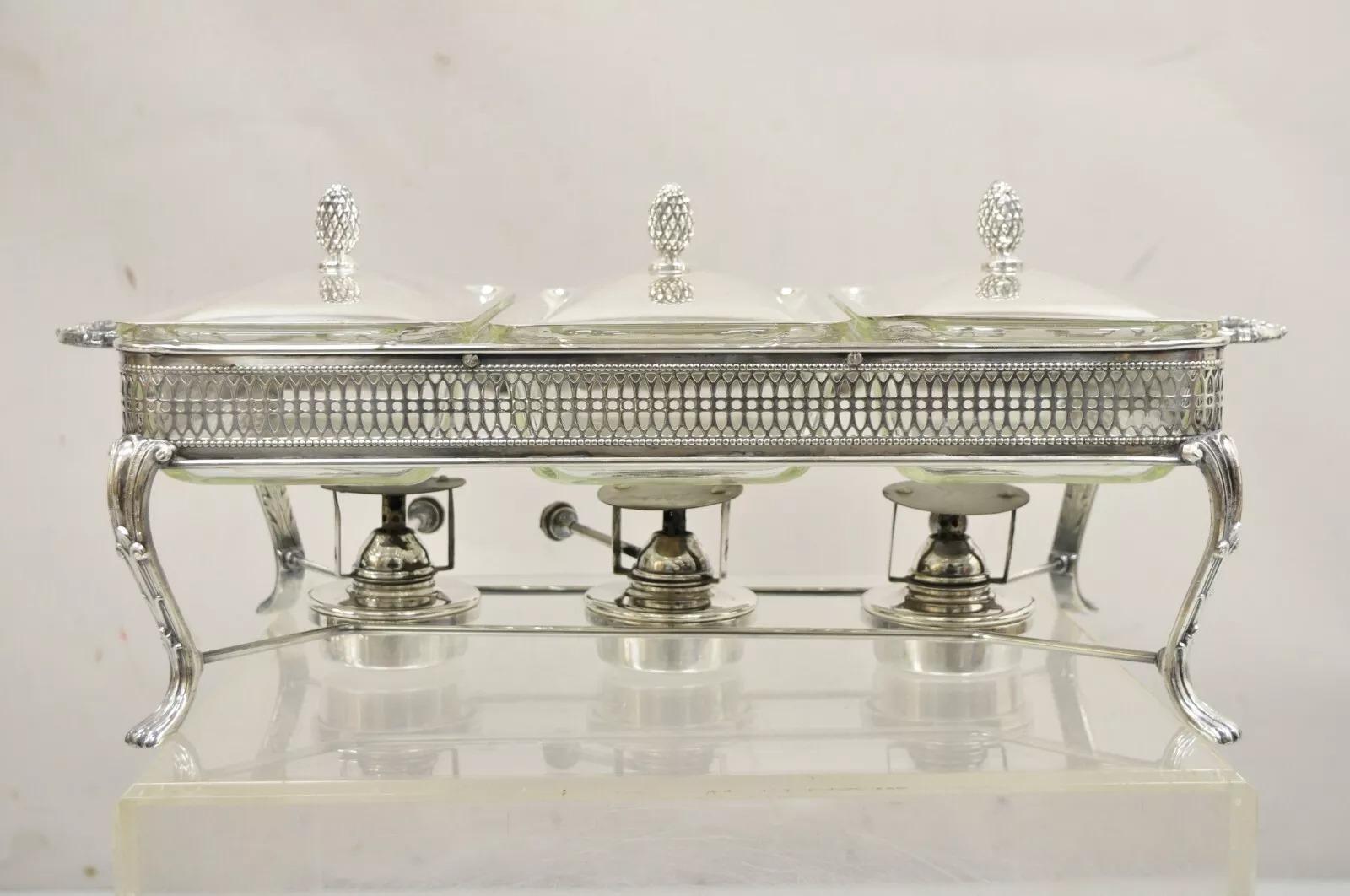 Vintage Sheffield Silver Co Silver Plated 3 Burner Warming Triple (1 Qt Each) Chafing Dish. Item features 3 glass Fire king (1 qt) dishes, silver plated frame and covers with acorn handles, 3 burners, original Sheffield hallmark. Circa Late 20th