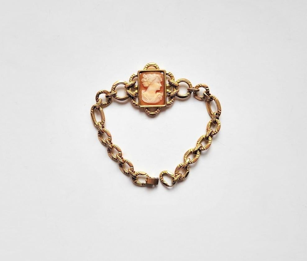 The lovely cameo bracelet has a surprising rectangular shell cameo and special carved links. This gold-filled bracelet is marked for Simmons on its fold-over clasp. It is 12k gold-filled.
Measurements: L 7