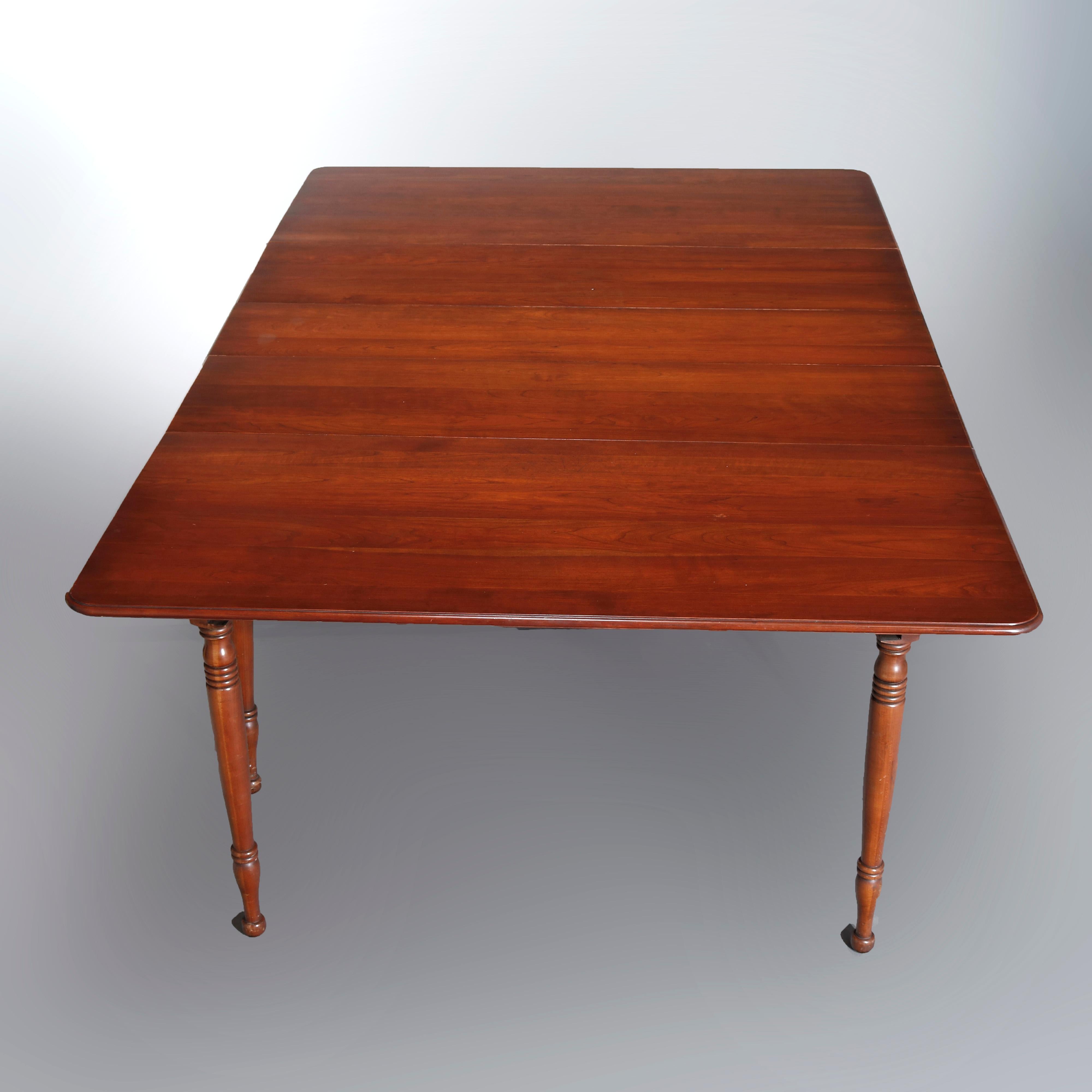 A vintage Sheraton style dining table by Pennsylvania House offers cherry construction with extension top having three 10.5