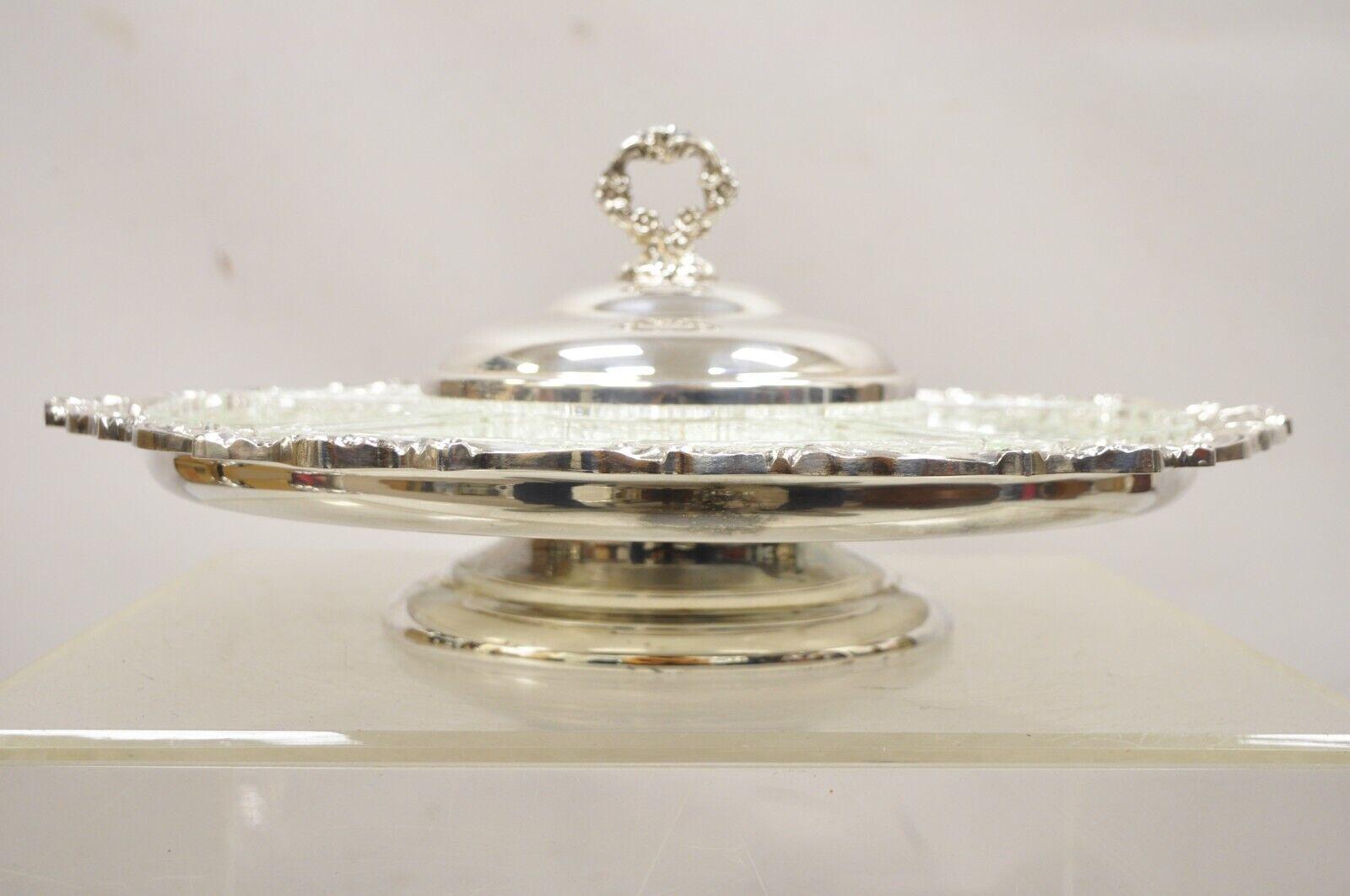 Vintage Sheridan Silver Plated Lazy Susan Revolving Serving Party Platter Tray with 5 Glass Inserts and 1 Glass Center Bowl with Lid.
Circa Mid 20th Century. Measurements:  7