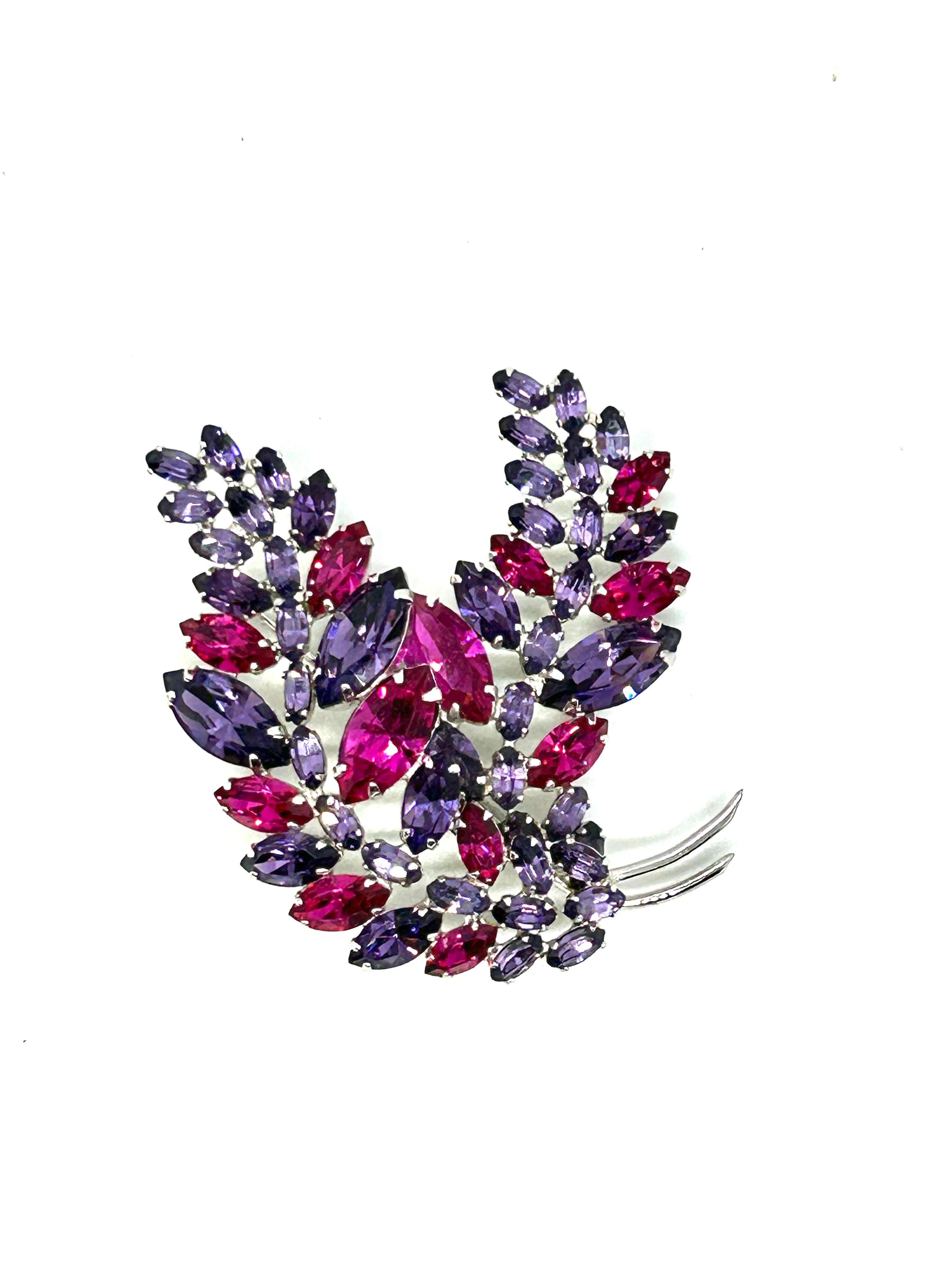 Very pretty pink and purple crystal brooch signed by Sherman.

In a very good condition with no missing stones and metalwork is good.

Rhodium plated metal and good working rollover clasp.

The stunning Navette crystals have beautiful colours,