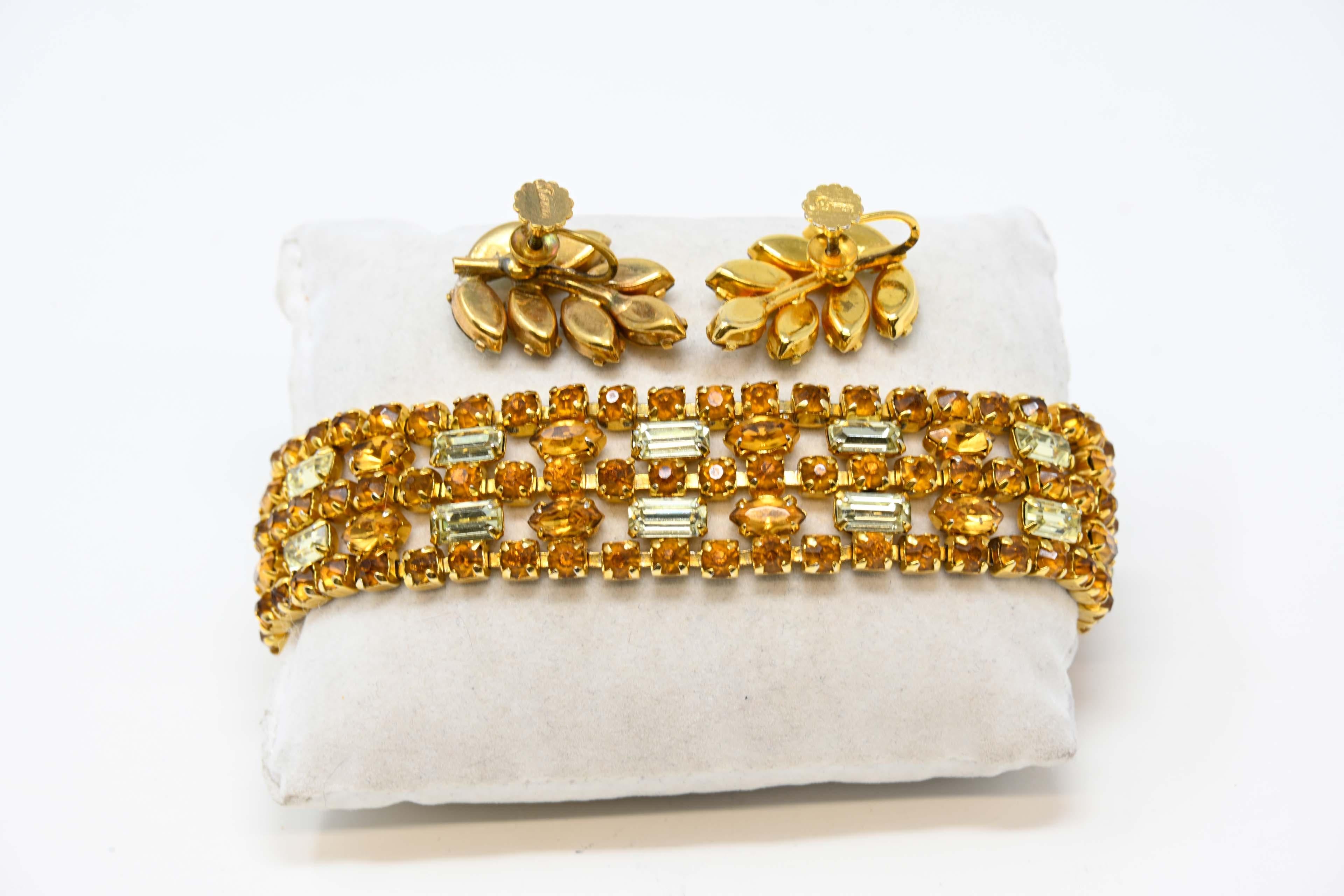 Signed Sherman 5-row bracelet and earrings with citrine color & cognac crystals. Marquise, round and baguette cuts with a safety chain.  Measures 2 cm wide x 19 cm long, circa 1952-1960. Made in Canada, preowned and in good condition.