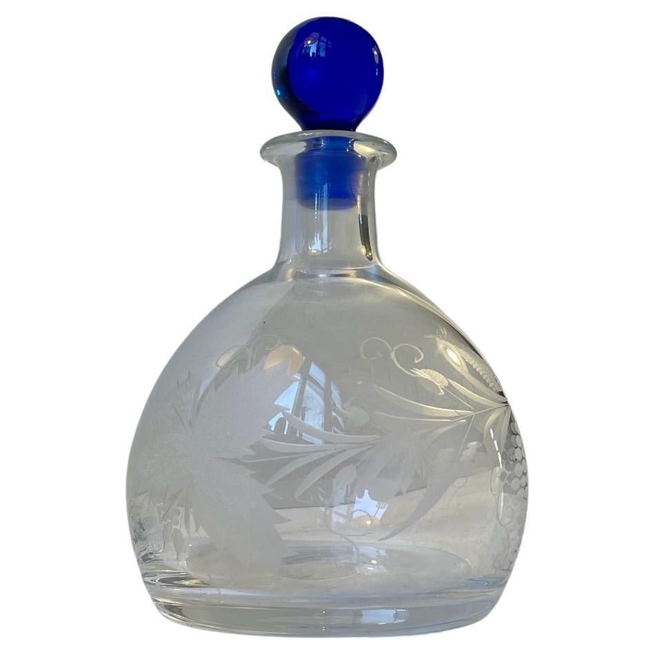 Fine hand-engraved and acid-etched decanter in blown glass. The blue original stopper, the engraved leaves and grapes indicates that it meant for storing sherry made from the grape/wine Palomino. However it will store and contain your whiskey,