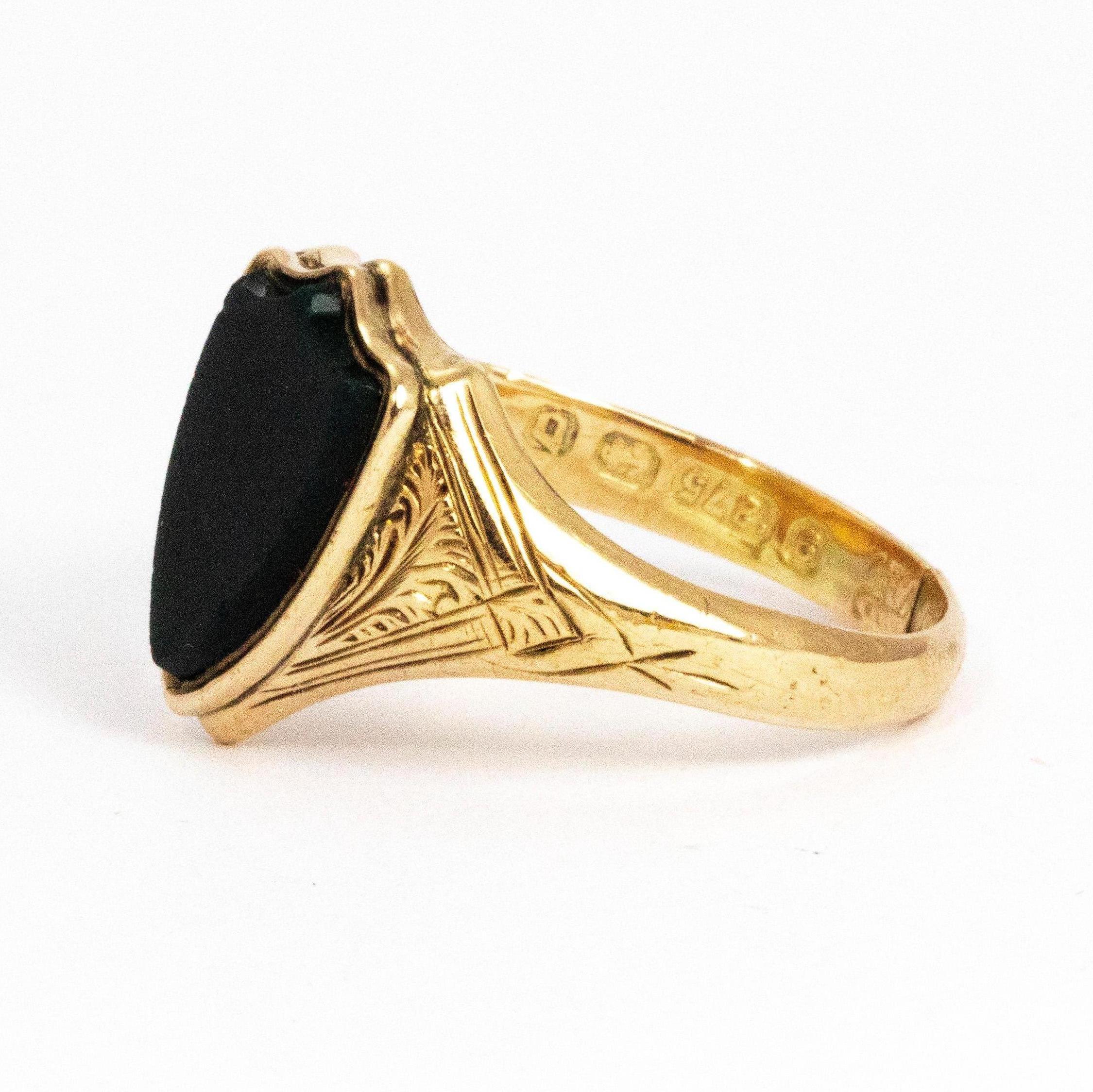 Modelled in 9ct gold this signet ring holds a gorgeous glossy bloodstone in the shape of a shield. The shoulders are beautifully engraved with leaf and scroll detail. Made in Birmingham, England.

Size: Q or 8 
Width Widest Point: 13.5 mm 