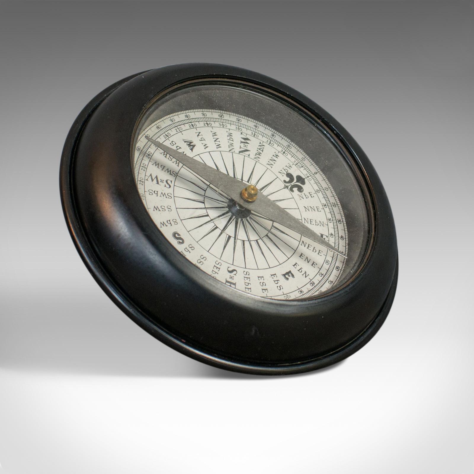 This is a vintage ship's compass. An English, steel, maritime navigation compass dating to the mid-20th century, circa 1950.

Displaying a desirable aged patina and a consistent color throughout
Pressed steel design with sealed compass