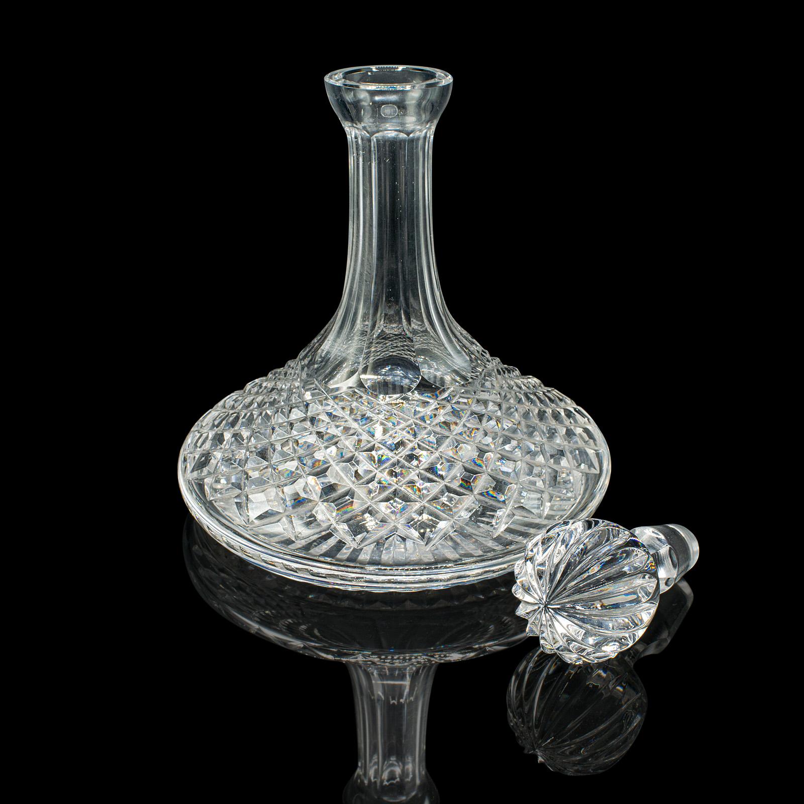 This is a handsome mid 20th century crystal decanter, with a classic ship’s form and brilliant cut finish, dating to circa 1960. This full-bodied wine or spirit decanter adds elegance to any drinks cabinet or bar setting.

Striking vintage ship’s