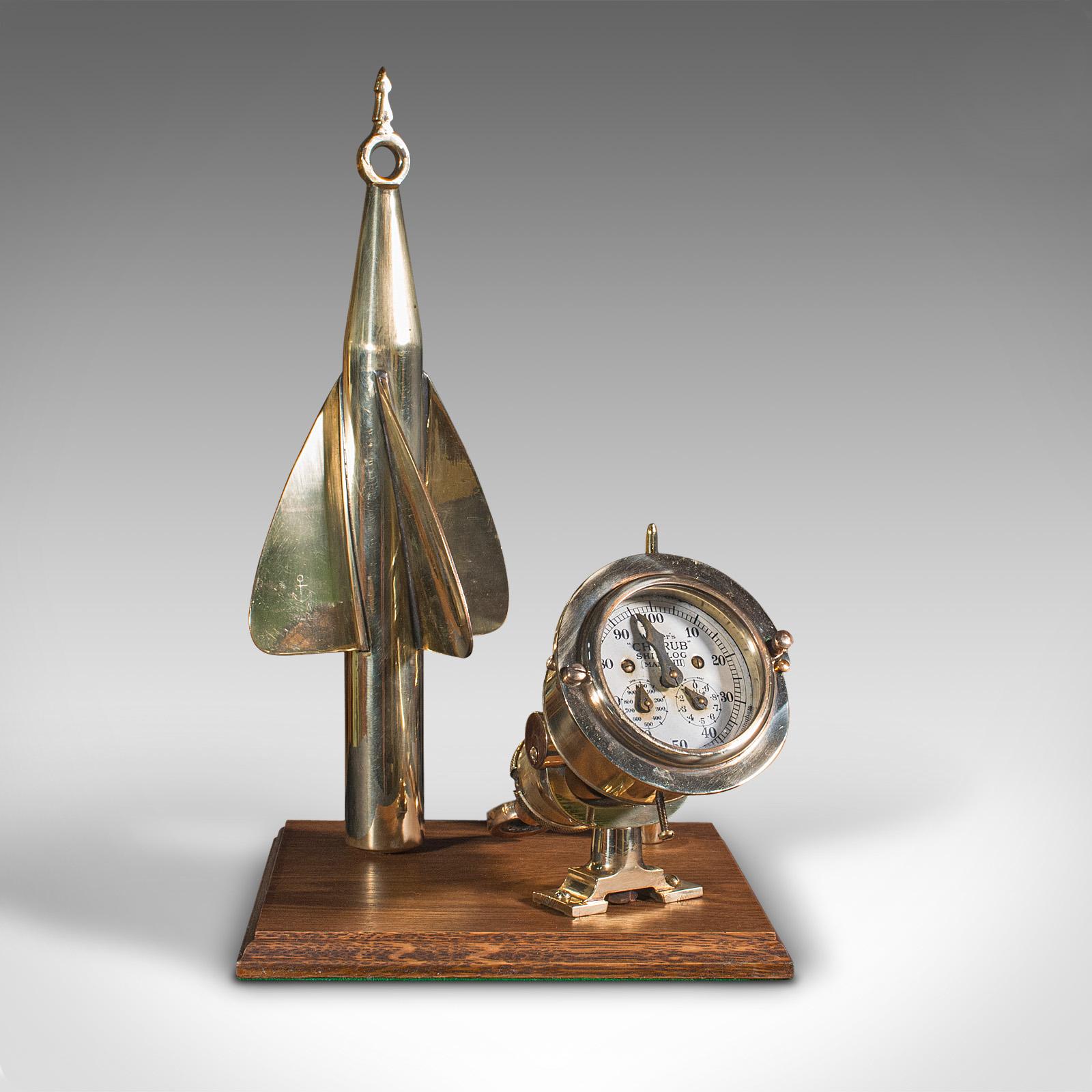 This is a vintage ship's log desk ornament. An English, brass and oak maritime display instrument, dating to the early 20th century, circa 1930.

Dashing nautical interest, presented for display
Displays a desirable aged patina and in good