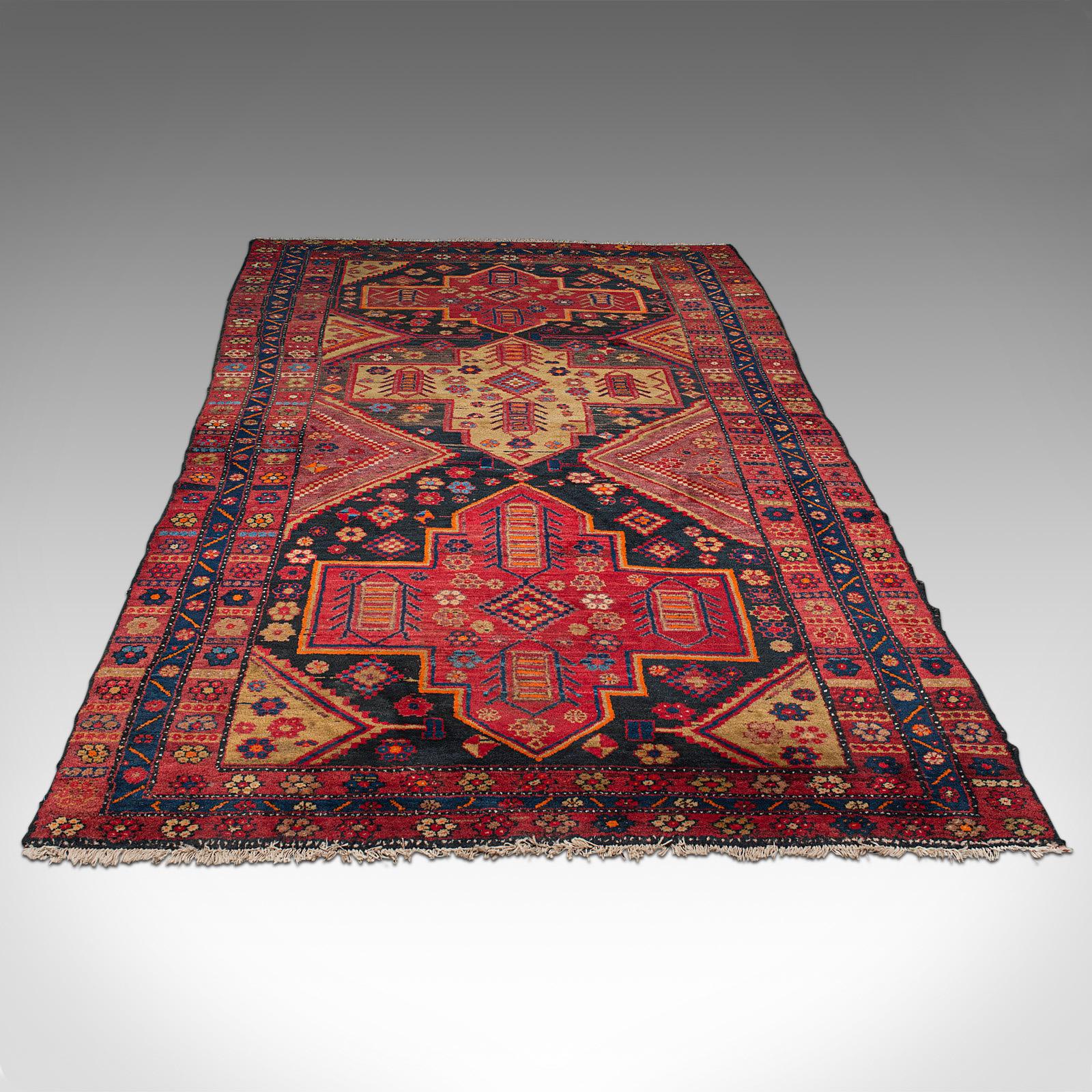 This is a vintage Shiraz decorative rug. A Persian, woven hall or lounge carpet, dating to the mid 20th century, circa 1940.

Of useful, near Qali size at 162cm x 305cm (63.75