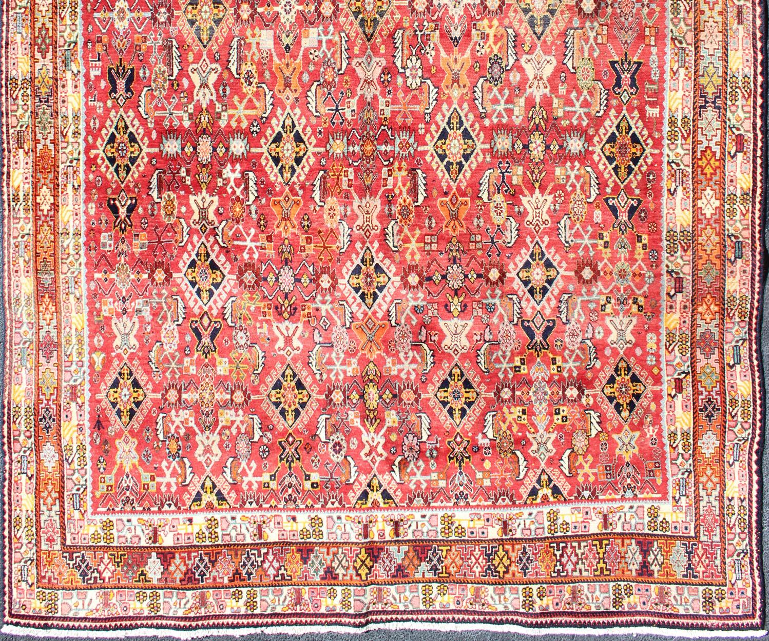 Beautiful red vintage Persian Qashqai rug with all-over Tribal Medallions and bright colors, rug H20-0902, country of origin / type: Iran / Qashqai, circa 1950

The Qashgai nomads are found in the Fars/Shiraz province in southwest Iran. They move