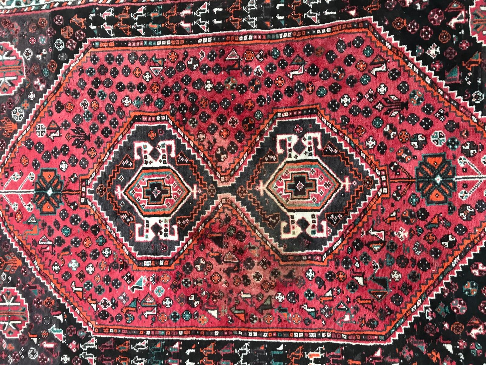 Beautiful mid-20th century rug with geometrical design and a red field color, entirely hand knotted with wool velvet on wool foundation.