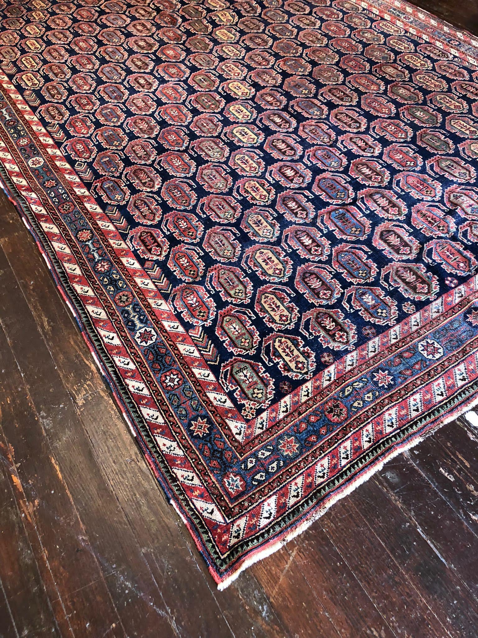 A magnificent Vintage Shiraz Rug is a testament to the beauty of traditional Persian craftsmanship, known for its bold colors and striking patterns. This particular rug is an exquisite piece that captures the essence of the Shiraz rug-making
