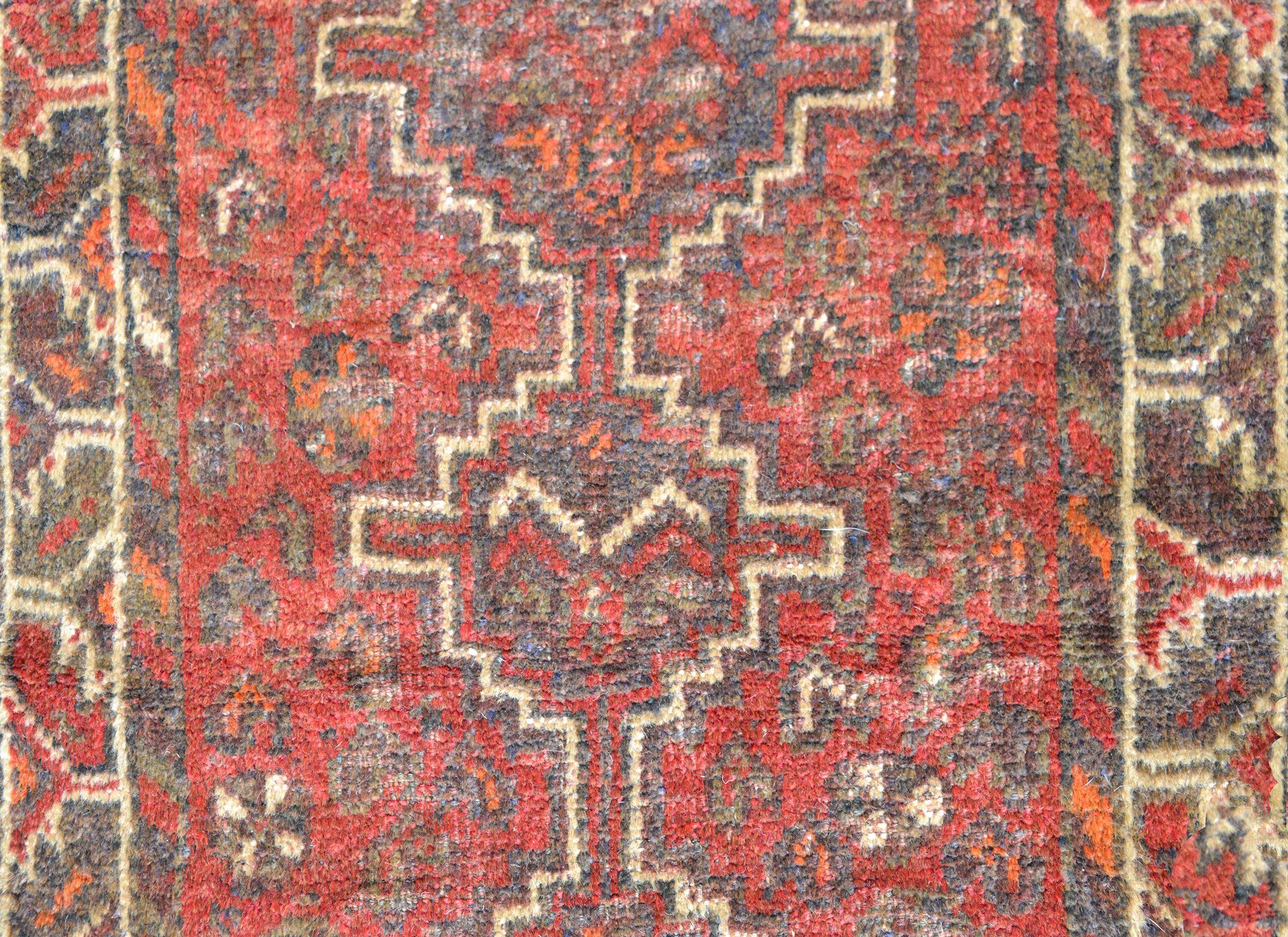 A beautiful vintage Shiraz rug with three diamond-form medallions against a field of stylized flowers and surrounded by a geometric stylized floral partnered border, and all woven in muted reds, blues, oranges, and cream.
