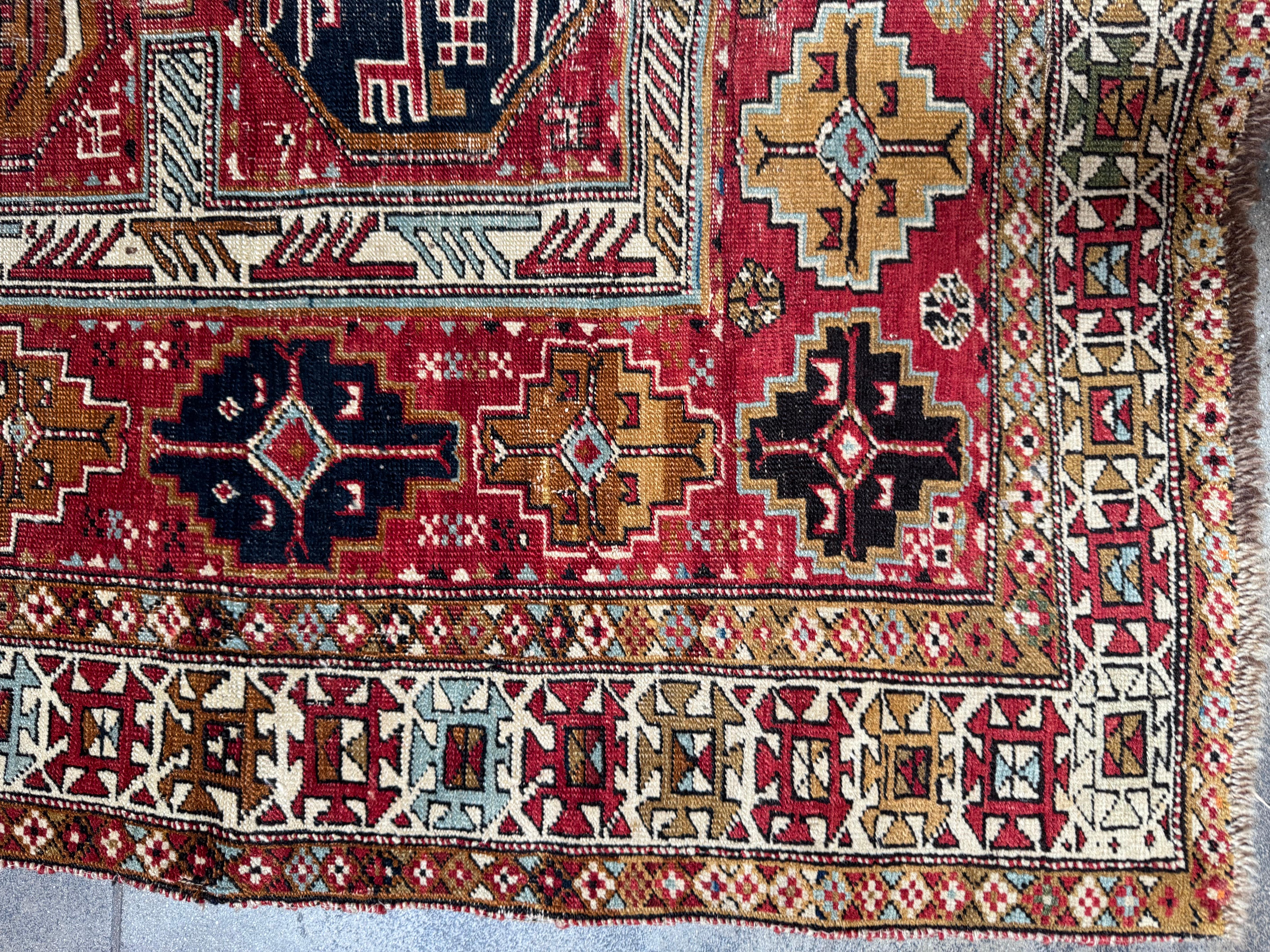 Step into a world of timeless artistry with this exquisite vintage Shirvan rug, a hand-knotted masterpiece that embodies the rich heritage of Persian craftsmanship. Woven with premium wool, this antique treasure features intricate tribal patterns in