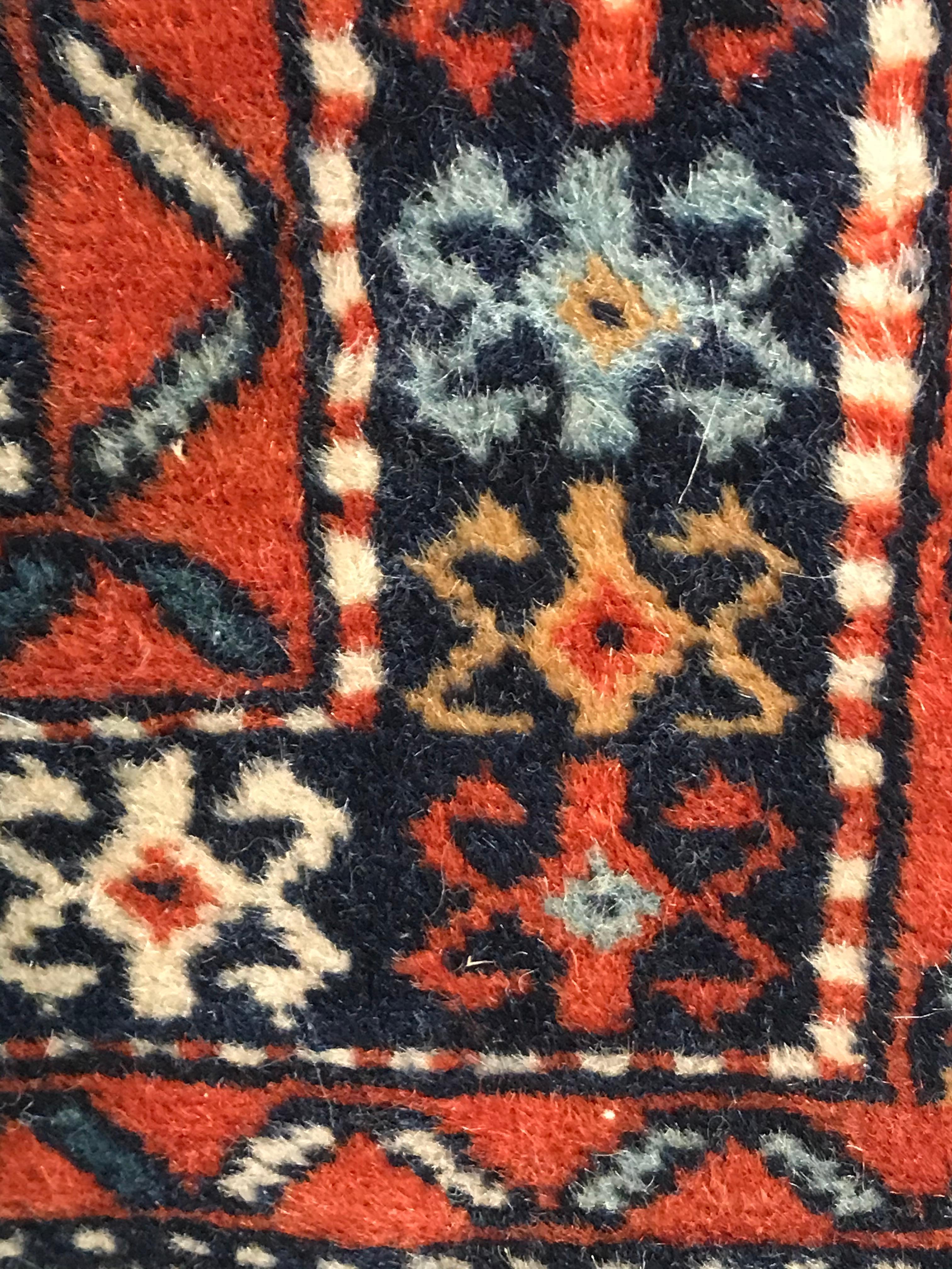 Vintage Shirvan rug, circa 1960. Beautiful geometric decor in dark and light blue, red, white and orange. The rug will ship from Europe, shipping costs to Boston are included. 

Shirvan is located just to the south of the Caucasus mountain range