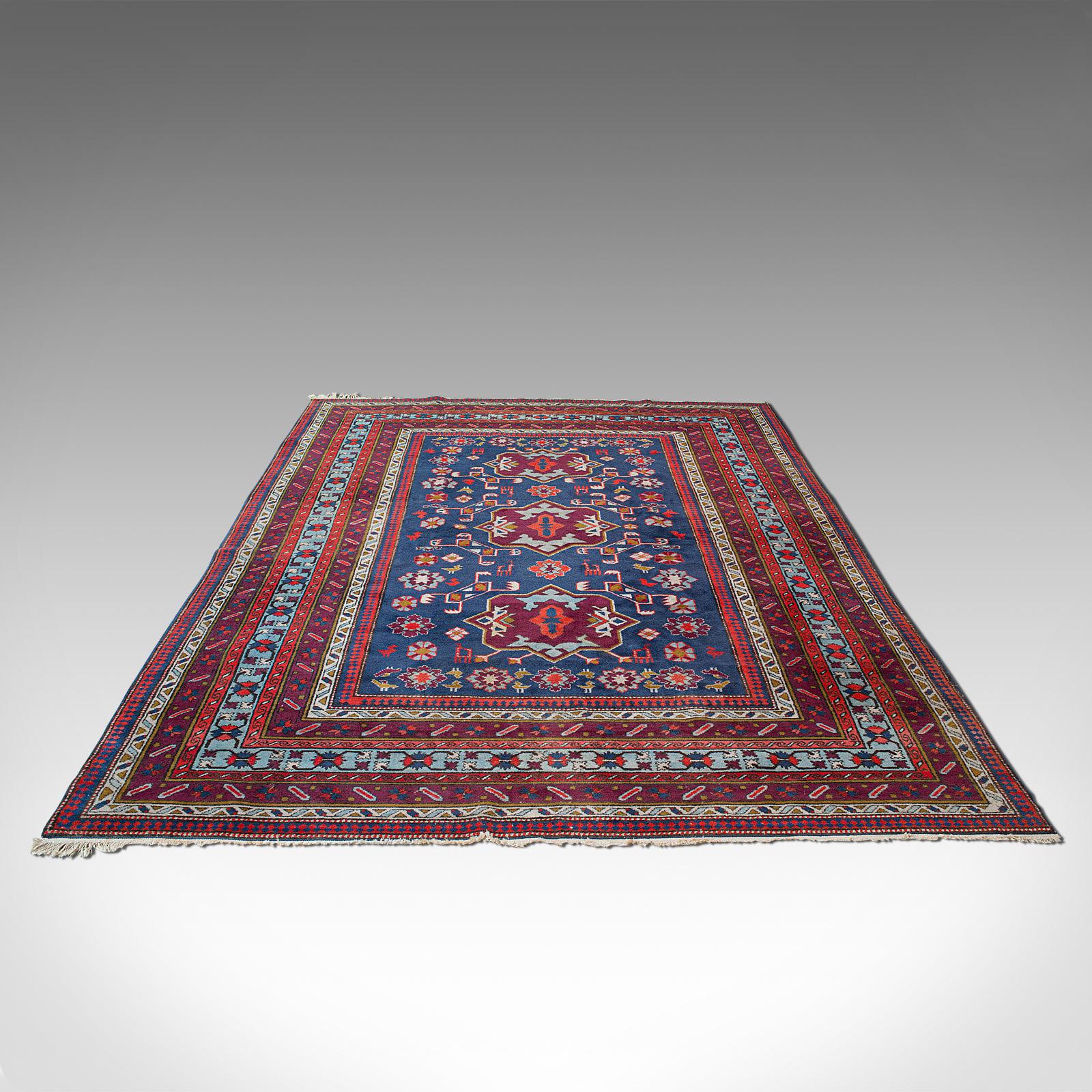 This is a vintage Shirvan rug. A Caucasian, woven pile lounge or hall carpet, dating to the mid 20th century, circa 1950.

Inviting colour and of good size at 207cm x 310cm (81.5