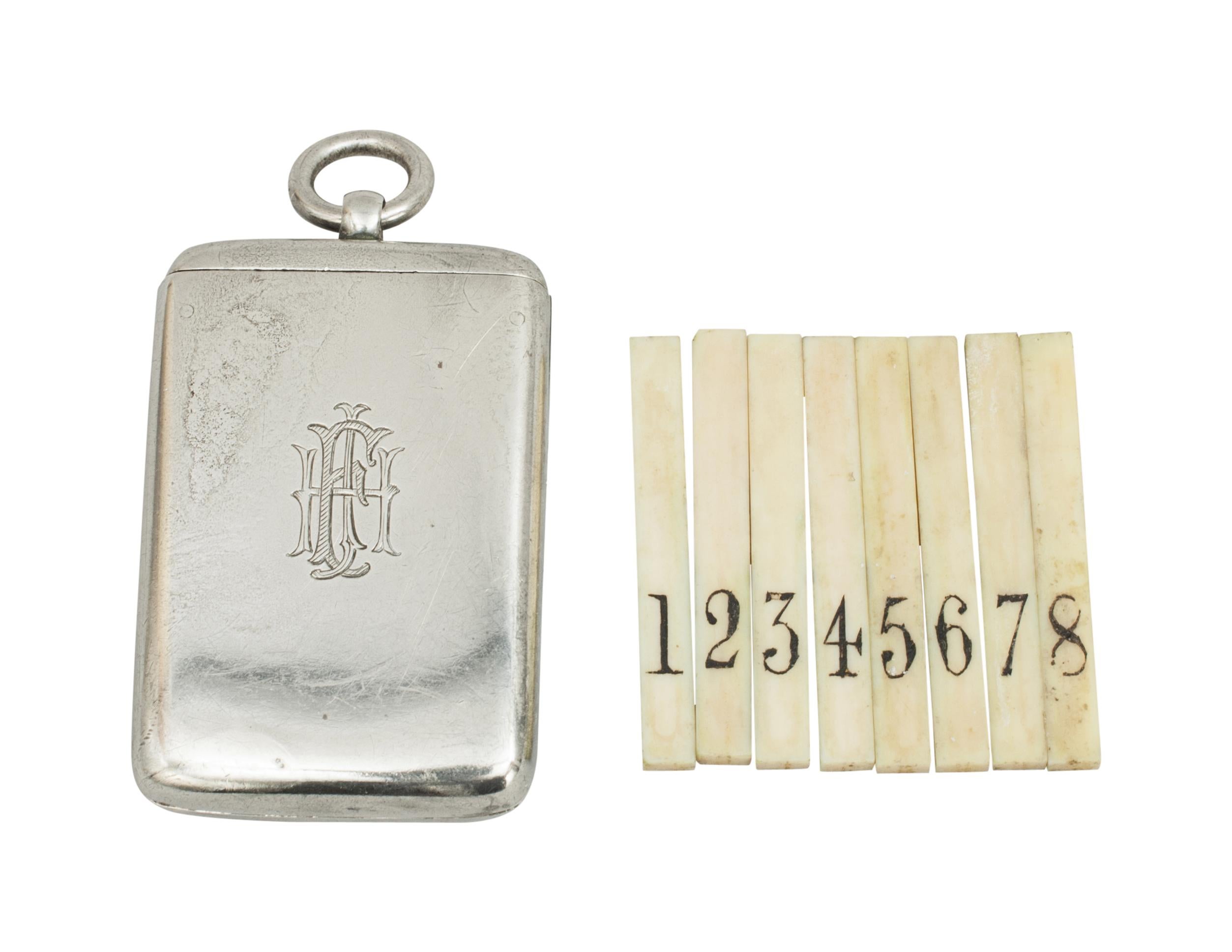 A well crafted and engineered silver plated shooting field place finder or butt marker. The case is very similar to a vesta case but when the top is slid back the interior pops up to reveal 8 removable numbered pegs. The pegs are made of bone and