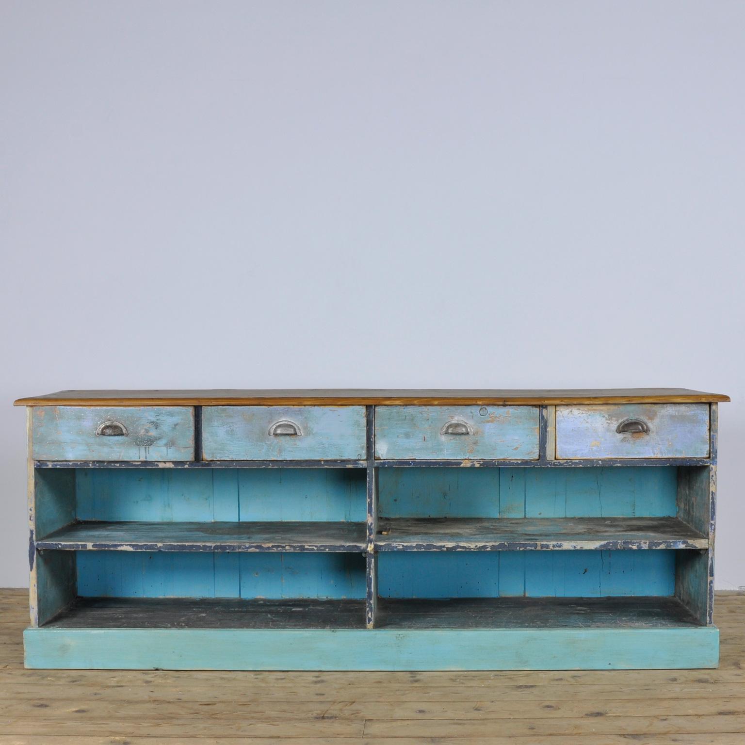 Fabulous vintage boutique counter table from circa 1920. Originally from a grocery shop in Budapest. A quality hand carpented piece, with drawers and practical shelving.

A fantastic item, just calling to be used as a console table or perhaps as a