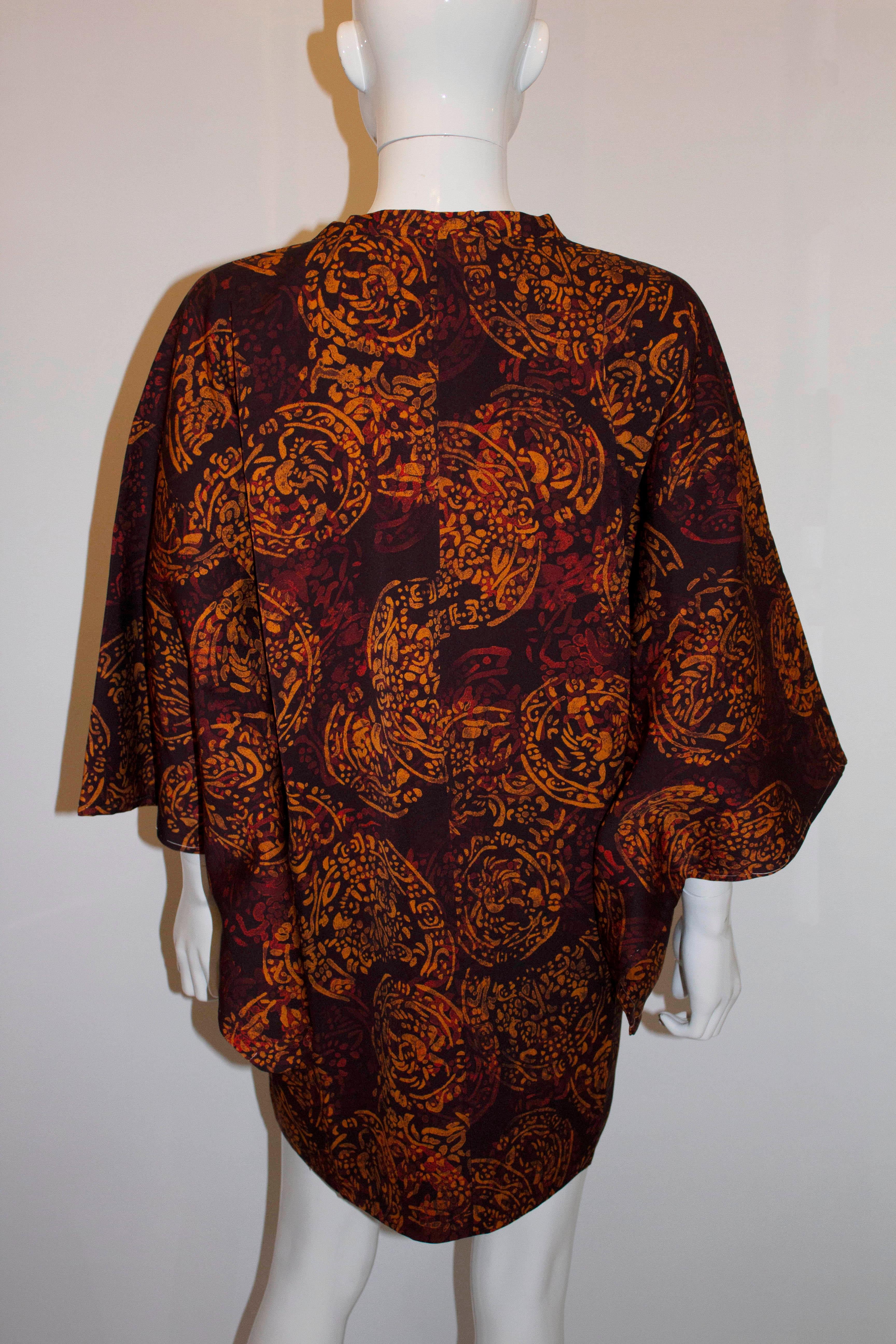 An  interesting vintage short kimono. The kimono has an unusual and interesting print showing ethnic tribal objects, possibly created  as a response to a Western exhibition in Japan. The kimono has a square neckline, internal waist ties and and