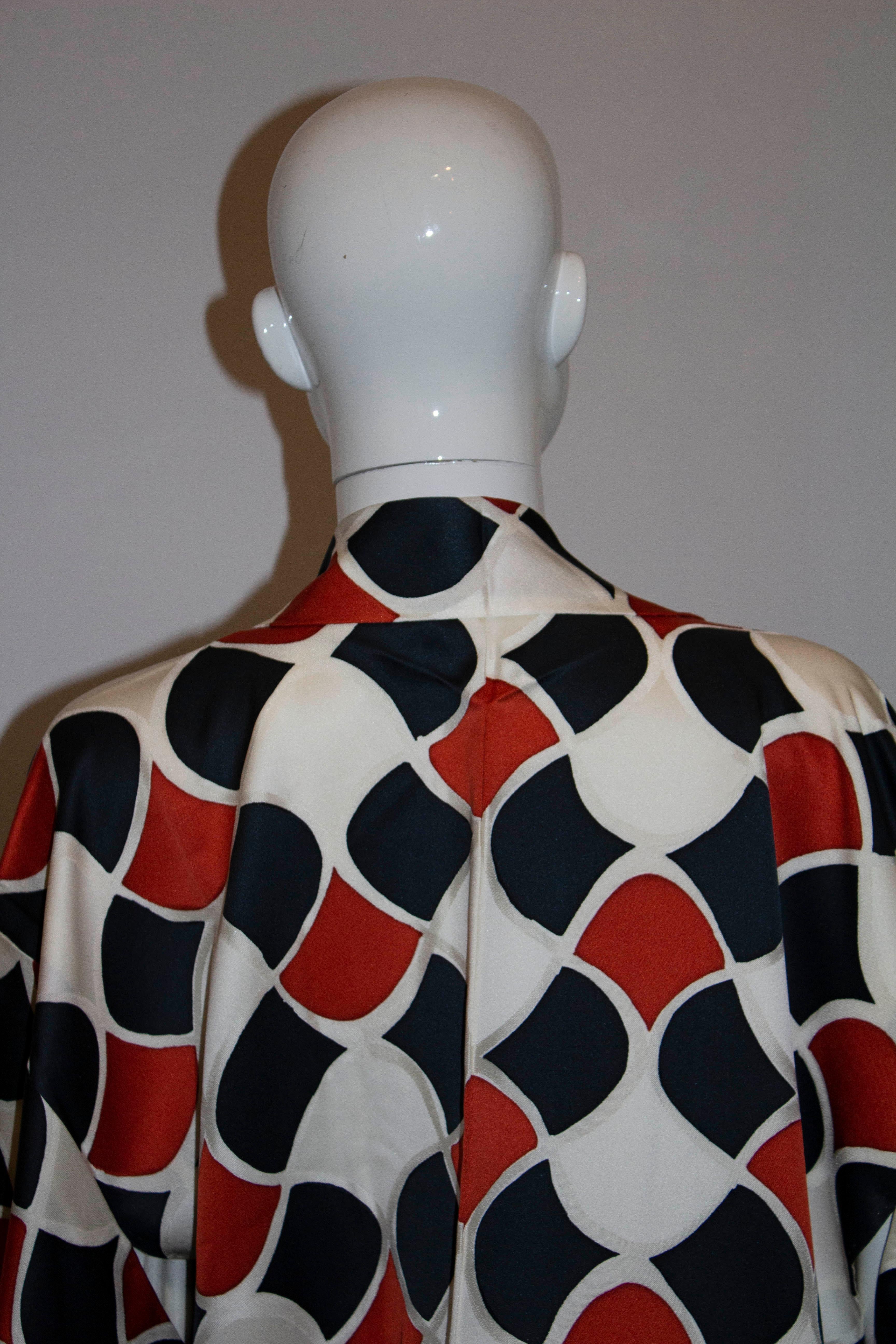 A fun vintage kimono in a rust, black and ivory print. Measurements : Bust up to 42'', length 33''