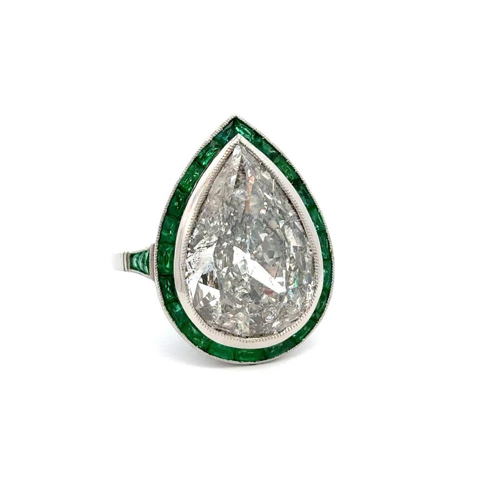 Simply Beautiful! Finely detailed Luxurious and Mesmerizing Statement Antique Pear Diamond and Emerald Show Stopper Platinum Ring. Centering a Gorgeous securely nestled Antique Pear Diamond, weighing approx. 9.12 Carat. Surrounded by Sparkling
