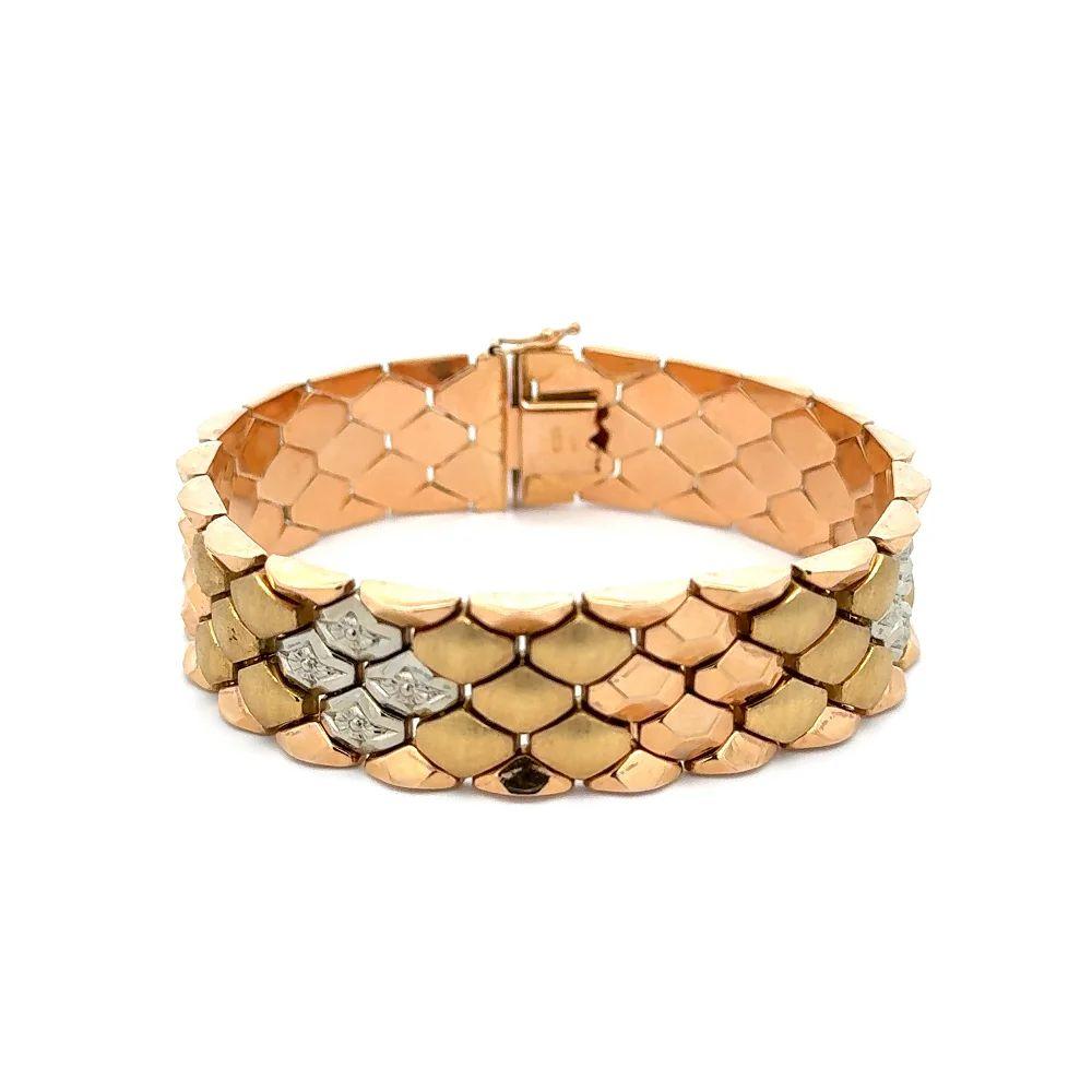 Simply Beautiful! Elegant and finely detailed Vintage Oscar Worthy Mid Century Modern Multi Texture Angular Wide Link Gold Statement Bracelet. Hand crafted in 2-tone 18K Yellow and White Gold. Measuring approx. 7.5” long x 0.70” wide. The Bracelet