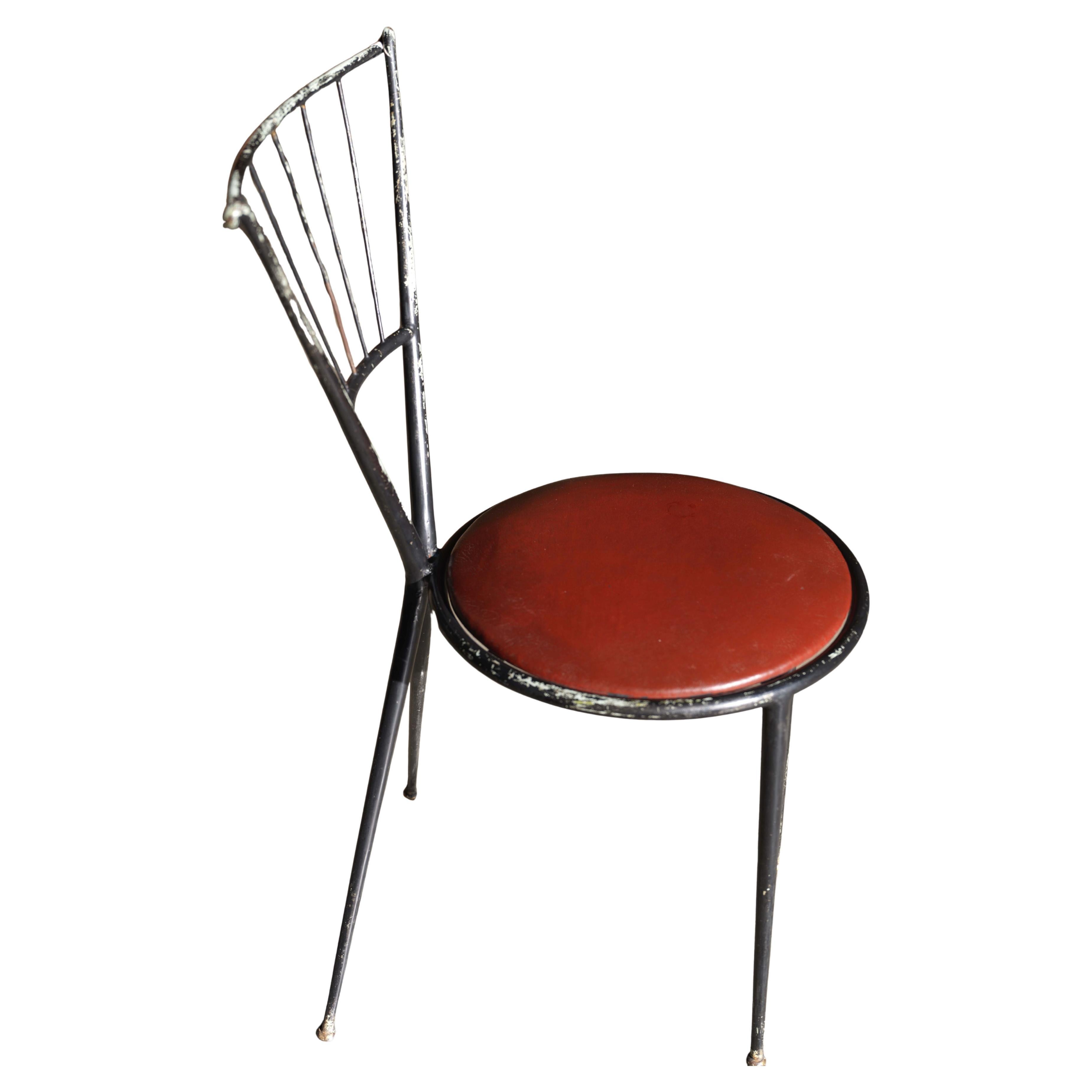 A striking mid-century side chair attributed to French designer Robert Lempereur, featuring a sculptural metal spindle frame and red leather seat. With its asymmetrical legs and airy yet bold presence, this piece is the perfect combination of form