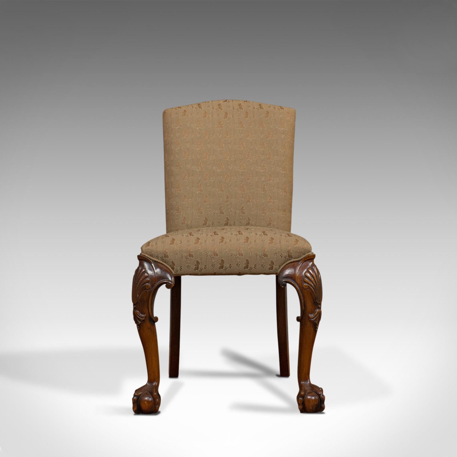 This is a vintage side chair. An English, mahogany Georgian-revival drawing room chair and dating to the 20th century.

Desirable color and patina to the mahogany frame
Quality carved detail throughout
Traditionally stuffed and finished
Fabric