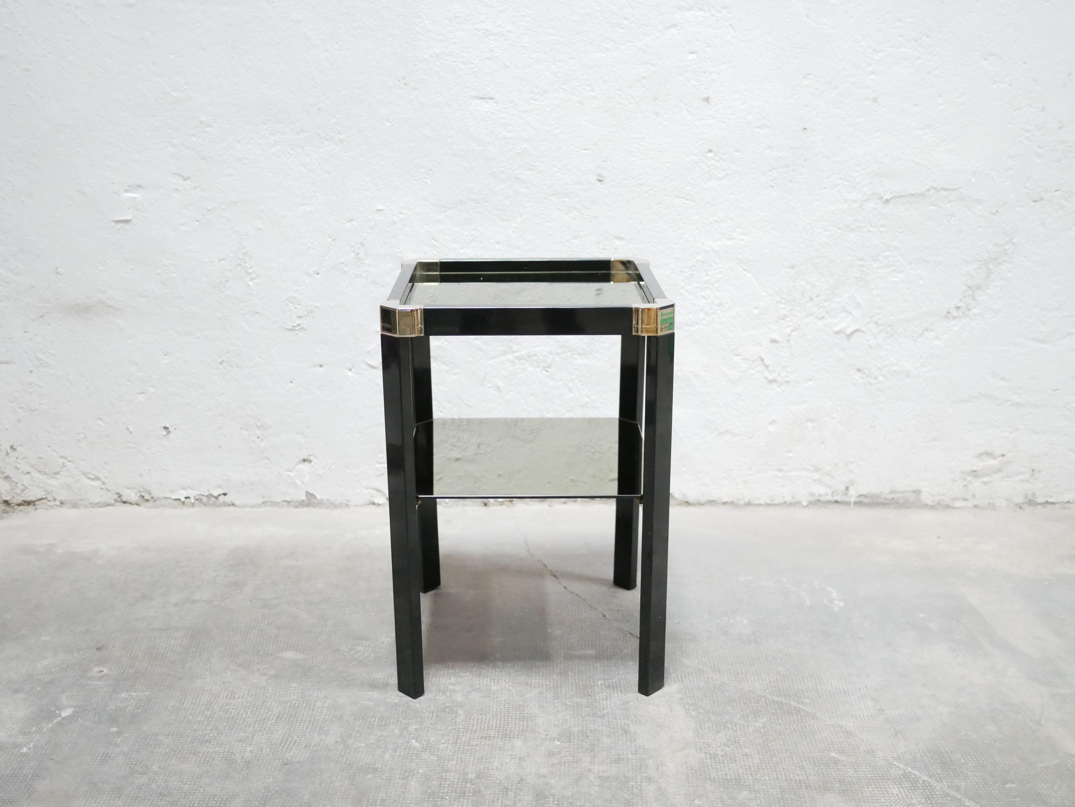 Vintage side table in black metal, brass and golden mirror attributed to Italian designer Romeo Rega, 70s.

Its lines give it a lot of elegance, character and refinement.
It will be perfect in the living room as a side table but also in the