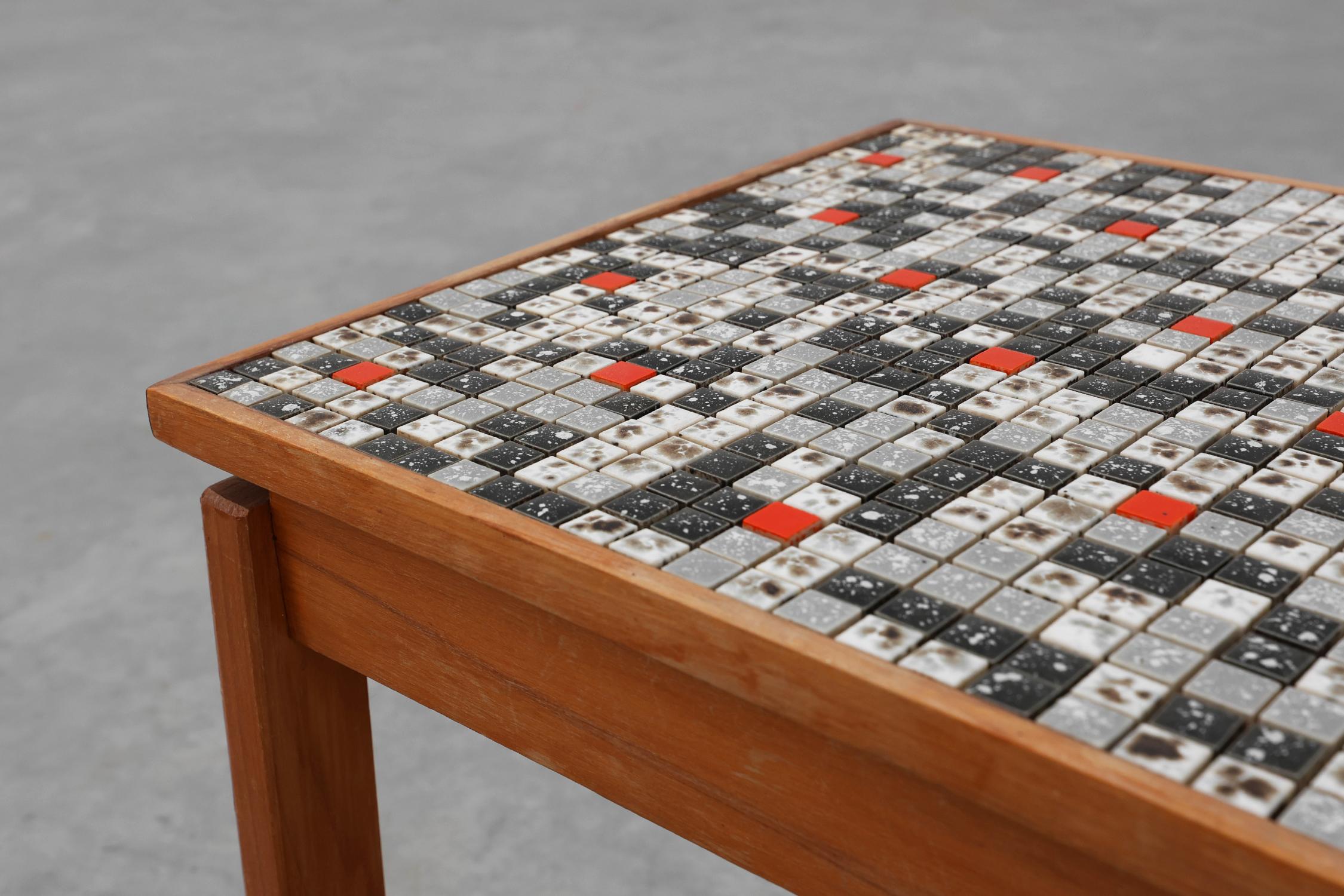 Belgium / 1950 / side table / wood, ceramics / Mid-century

Small charming side table tiled with red, white, black and gray mosaic. The sleek frame is made of solid wood and forms the basis for the striking ceramic table top. The glazed tiles in