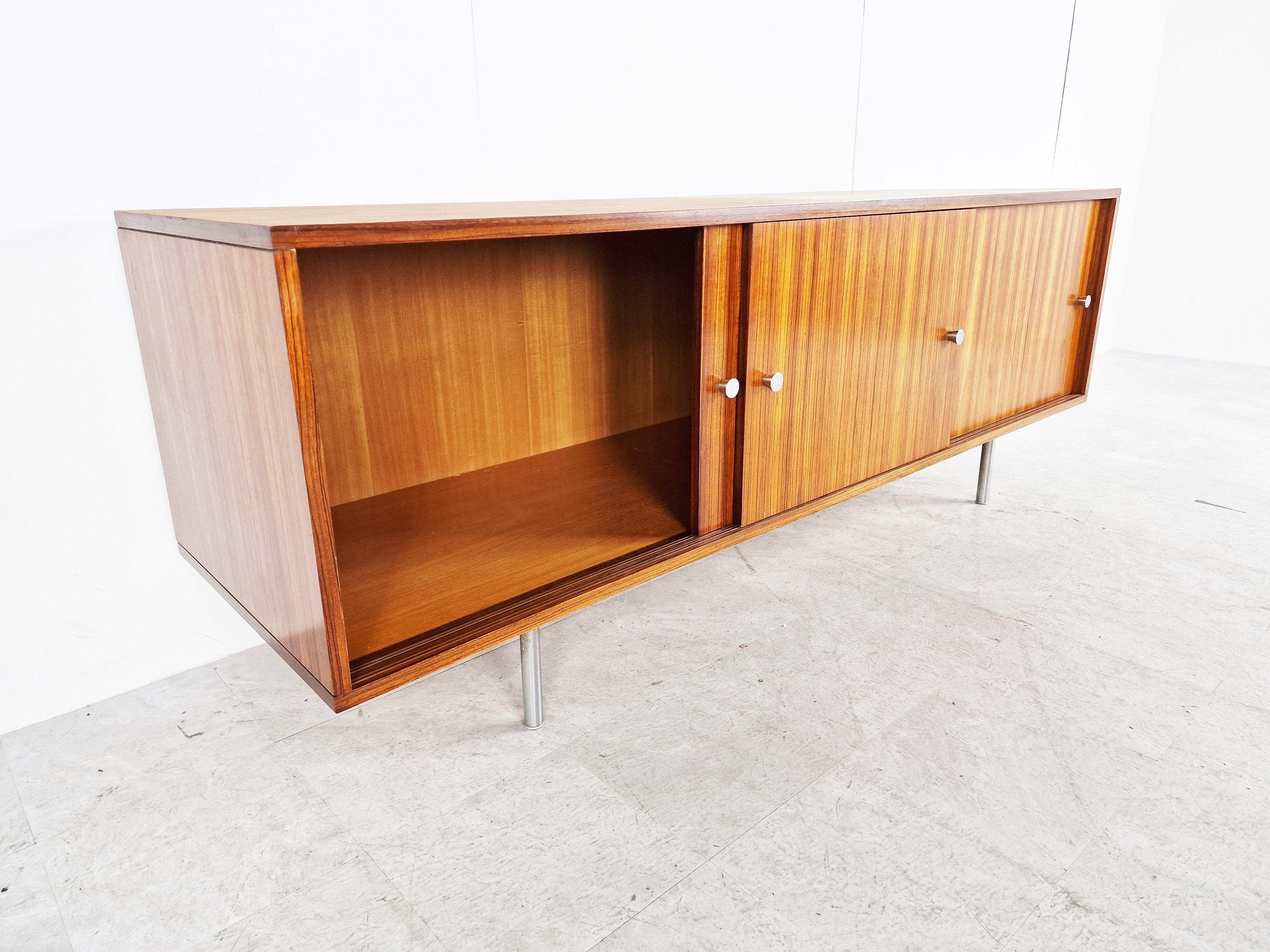 Timeless mid century sideboard by Alfred Hendrickx.

The sideboard offers a lot of storage space, because it's deeper then most sideboards.

It has three sliding doors.

1960s - Belgium

Overall good condition, some discolouring on the