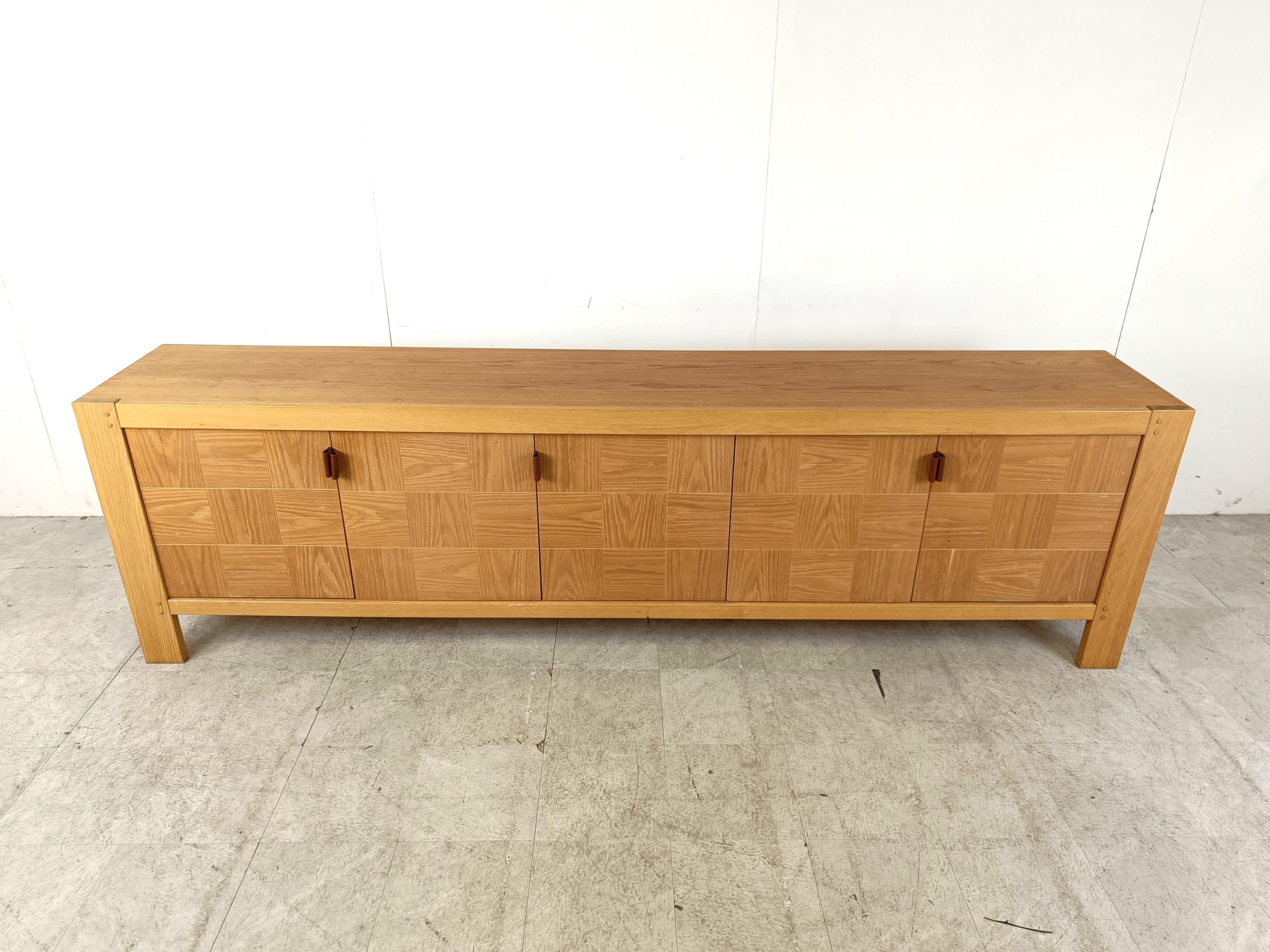Brown 5 door credenza or sideboard by Frans Defour for Defour.

Beautiful timeless sideboard with inlaid grained oak tiles and leather door handles.

The sideboard offers plenty of storage space.

Good condition

1970s - Belgium

Dimensions:
Lenght: