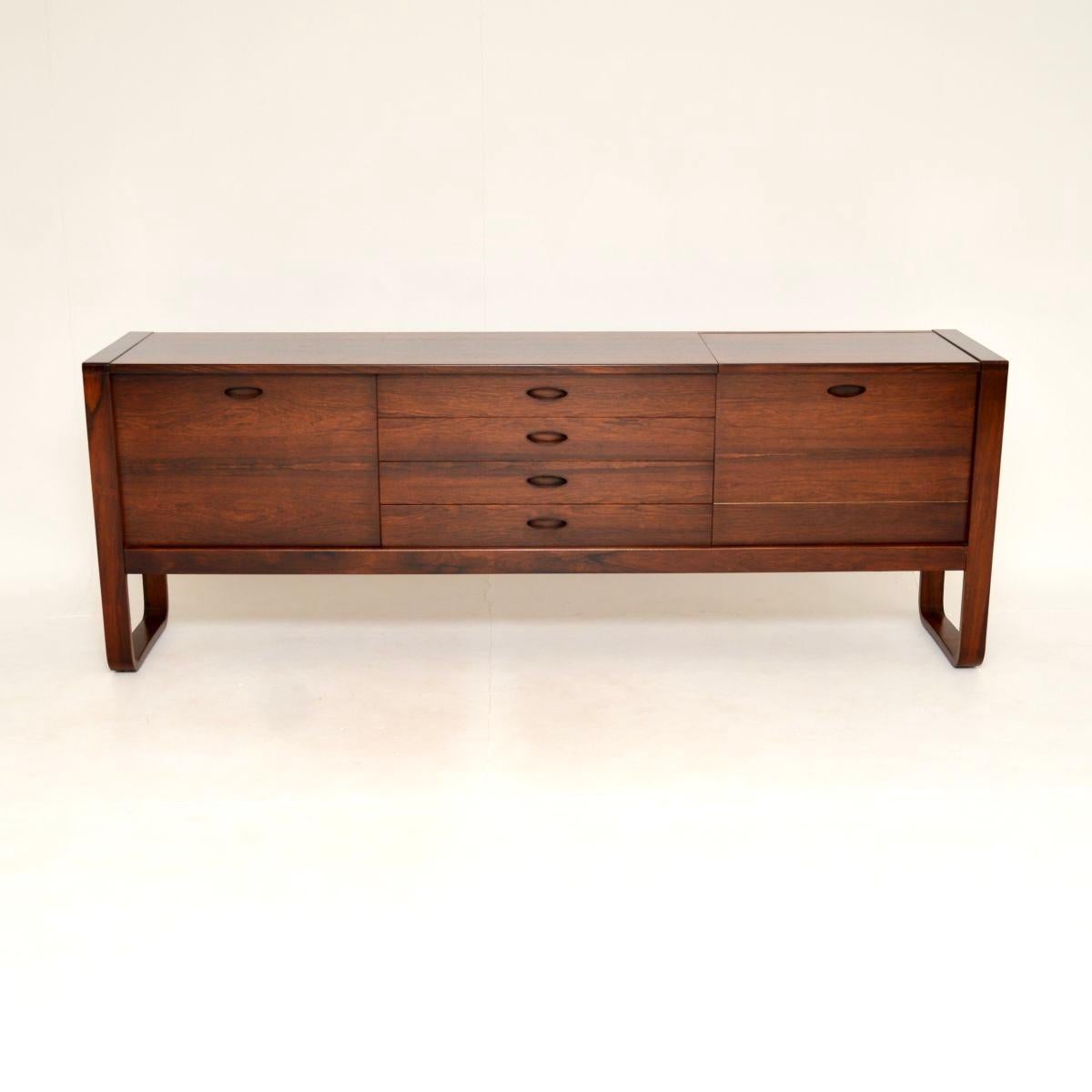 A superb vintage sideboard by Gunther Hoffstead for Uniflex. This was made in England, it dates from the 1960’s.

The design is stunning, this is extremely well made with many fine features. The U shaped sides are characteristic of Hofftstead’s