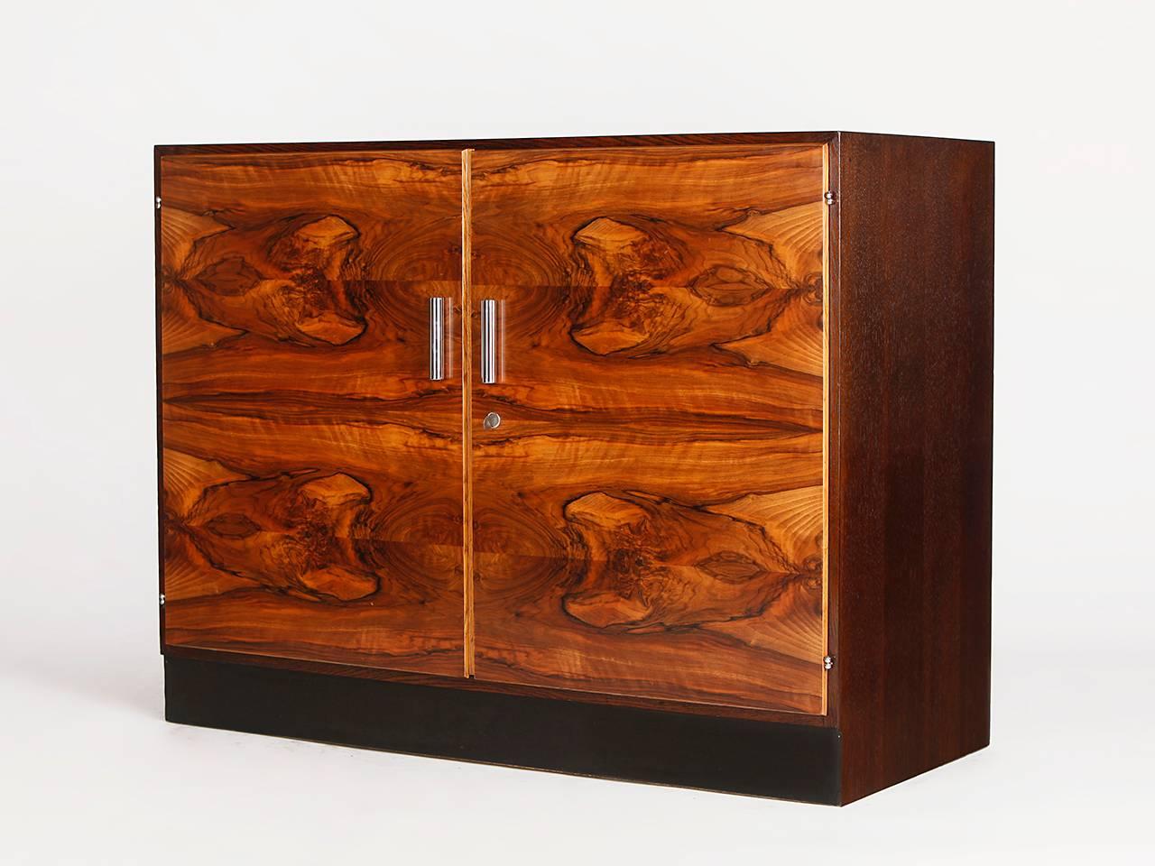 Designed by Jindrich Halabala in the 1930s. Made in the former Czechoslovakia by UP Závody. Corpus of stained oak. Doors veneered with Caucasian walnut. 
Partly restored, very nice vintage condition.

 
