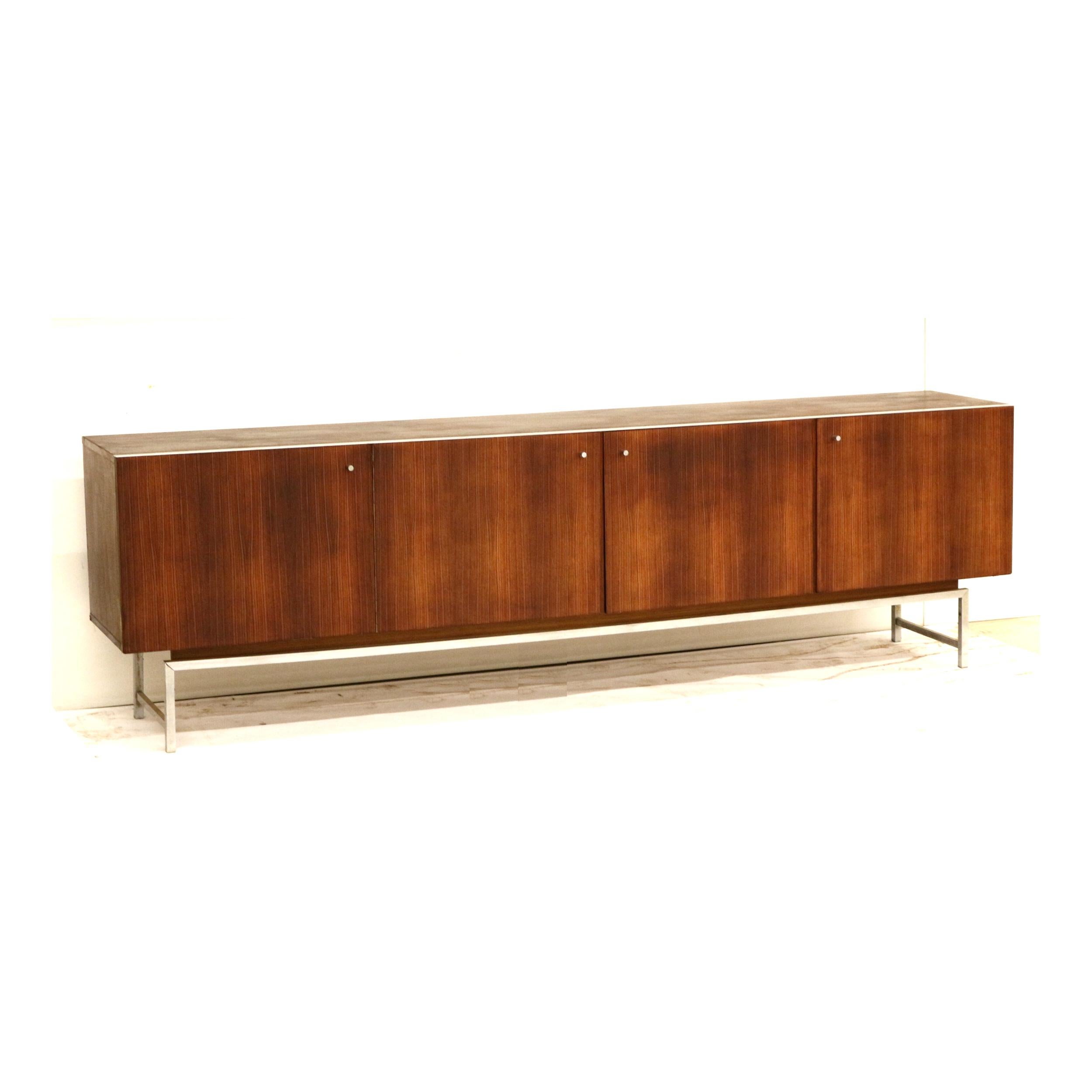 Vintage sideboard by Kurt Günter and Horst Brechtmann for Fristho from 1961.

Dimensions:
Width: 243.2 cm
Height: 73.3 cm
Depth: 45 cm

The sideboard has minor signs of use appropriate to its age. The sideboard only has shelving. 