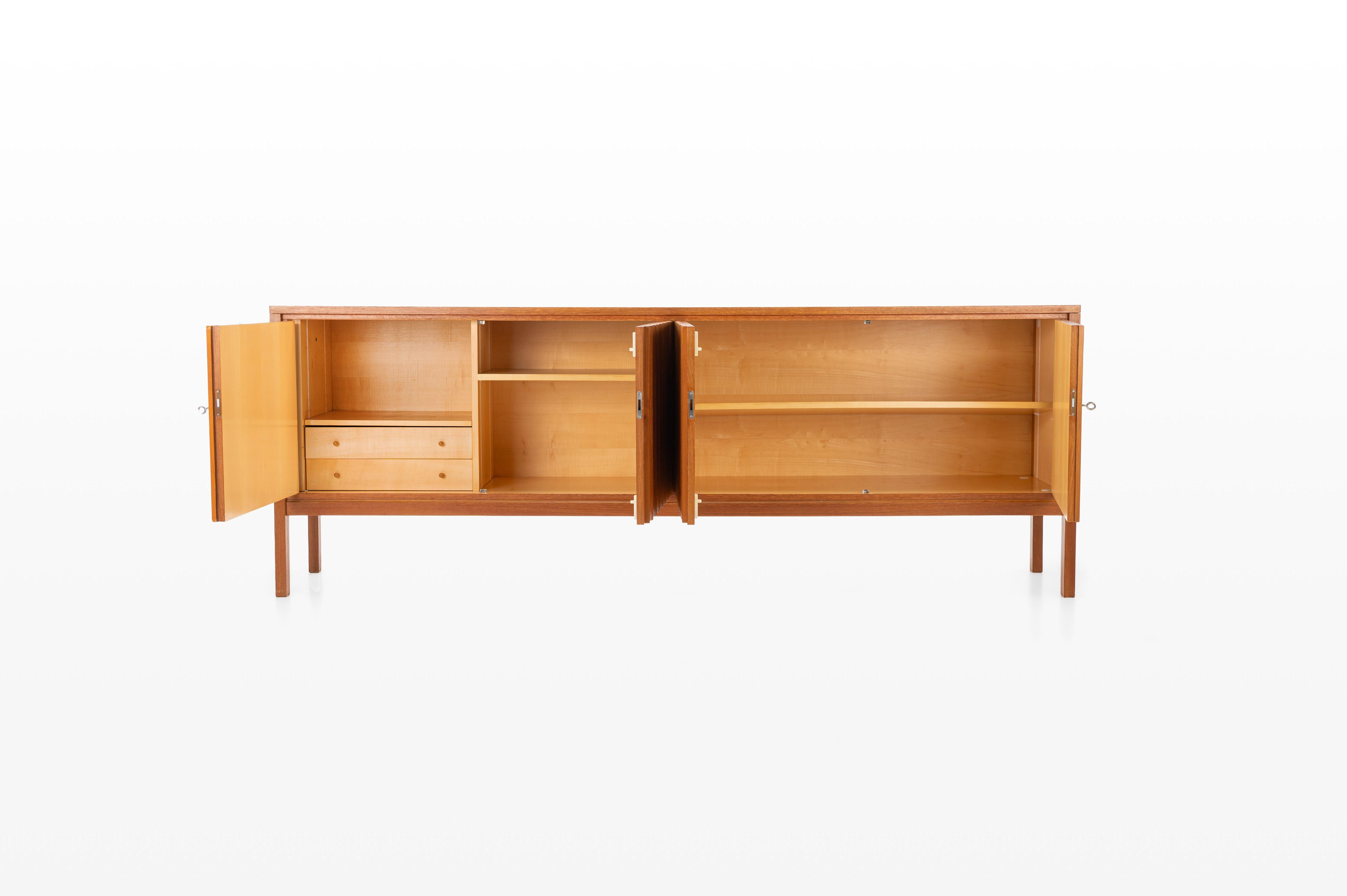 Beautiful sideboard by Leo Bub for BUB Wertmöbel. This sideboard is a true collector’s piece, featuring four hinged doors, two inner drawers, and a lot of storage space. Made of teak wood, it is in great condition.

Dimensions:
W: 232,5 cm
D: 43,5