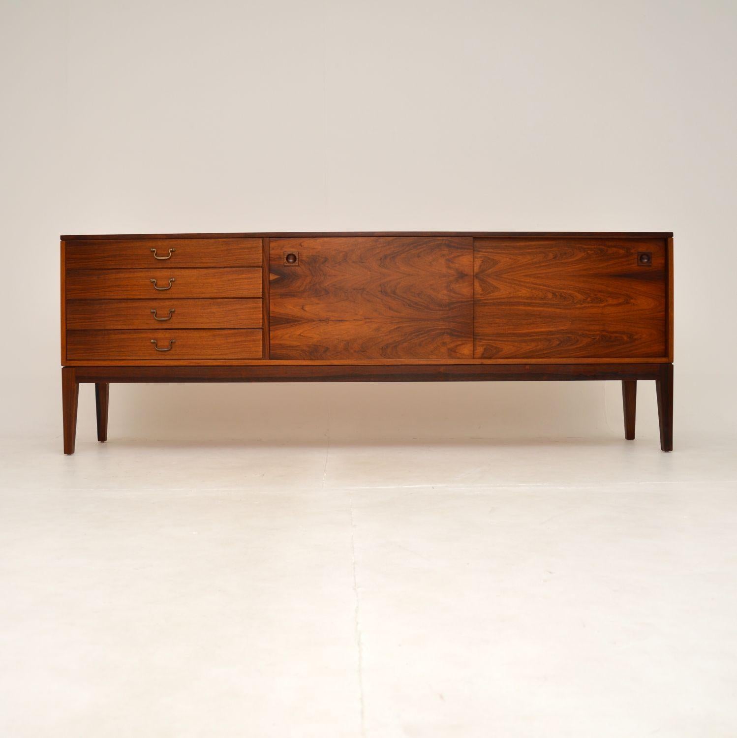 An absolutely stunning and extremely well made vintage sideboard by Robert Heritage for Archie Shine. This was made in England, and dates from the 1960’s.

The quality is outstanding, this sits on beautifully tapered legs, with two sliding doors on