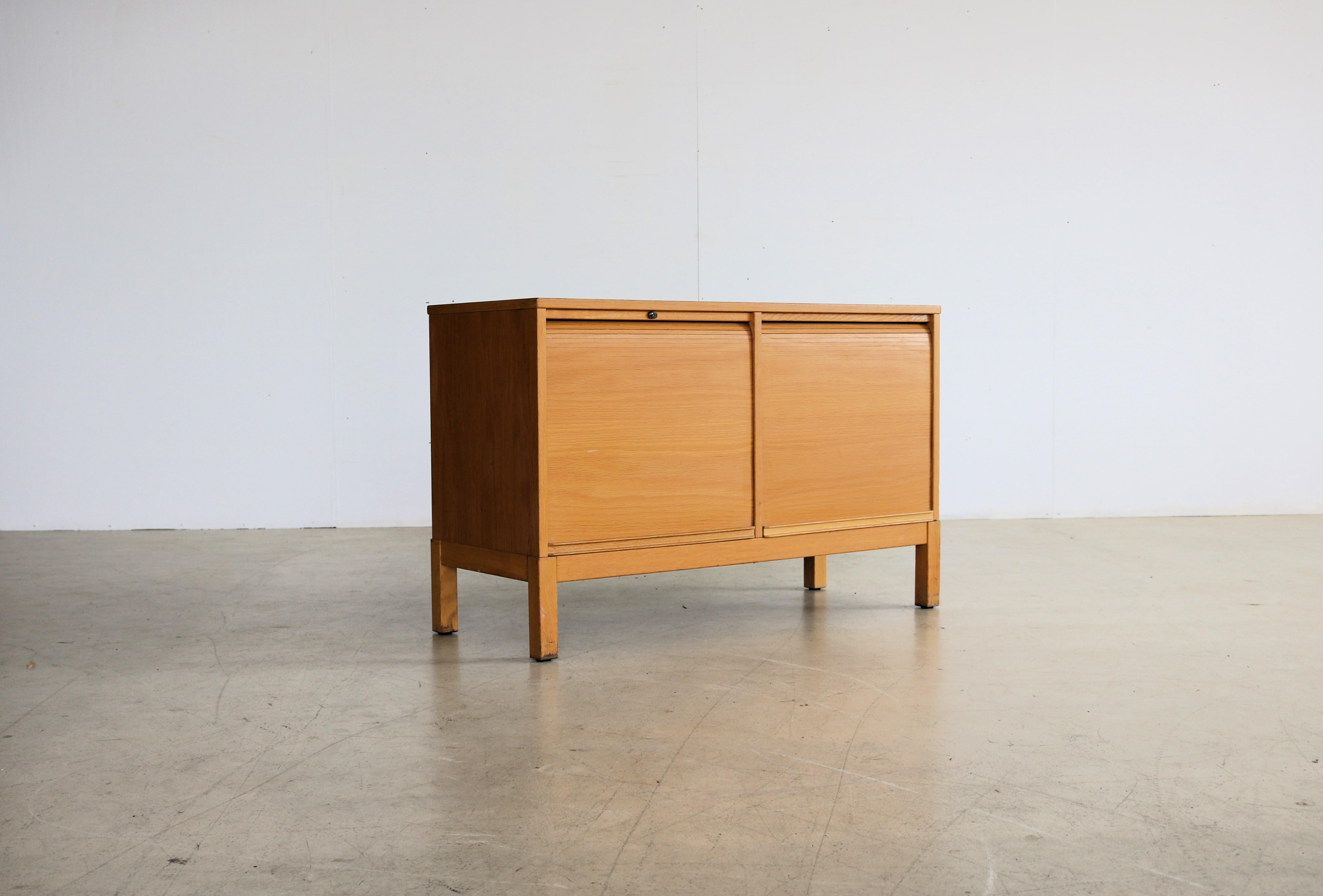 vintage sideboard | filing cabinet | 70s | Kinnarps

period | 70s
designs | Kinnarps | Sweden
conditions | good | light signs of use | key is missing
size | 66 x 104 x 41 (hxwxd)

details | oak; beech; tambour doors;

article number | 2094