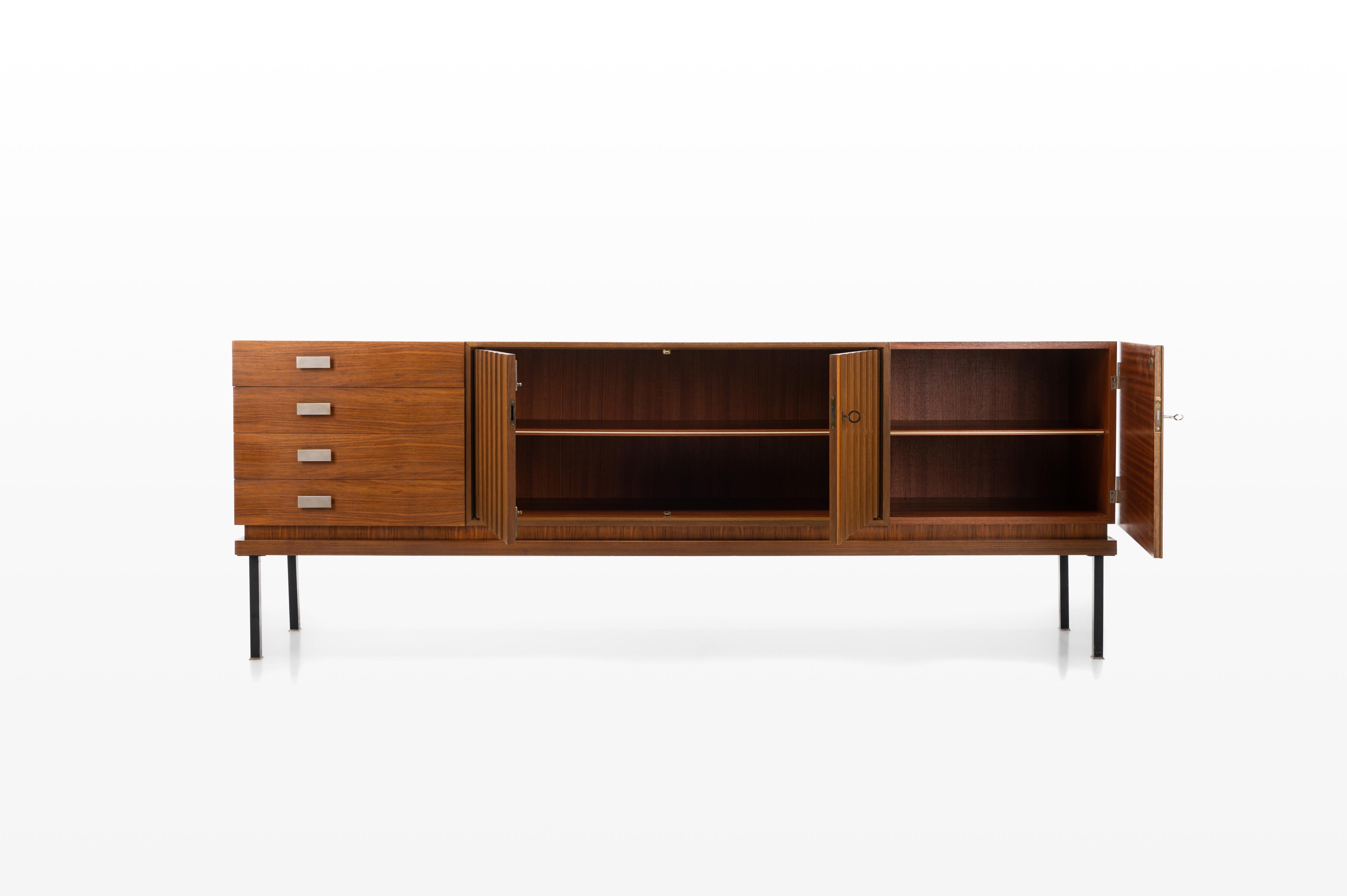 This vintage sideboard has four drawers, three doors and plenty of storage space.
 