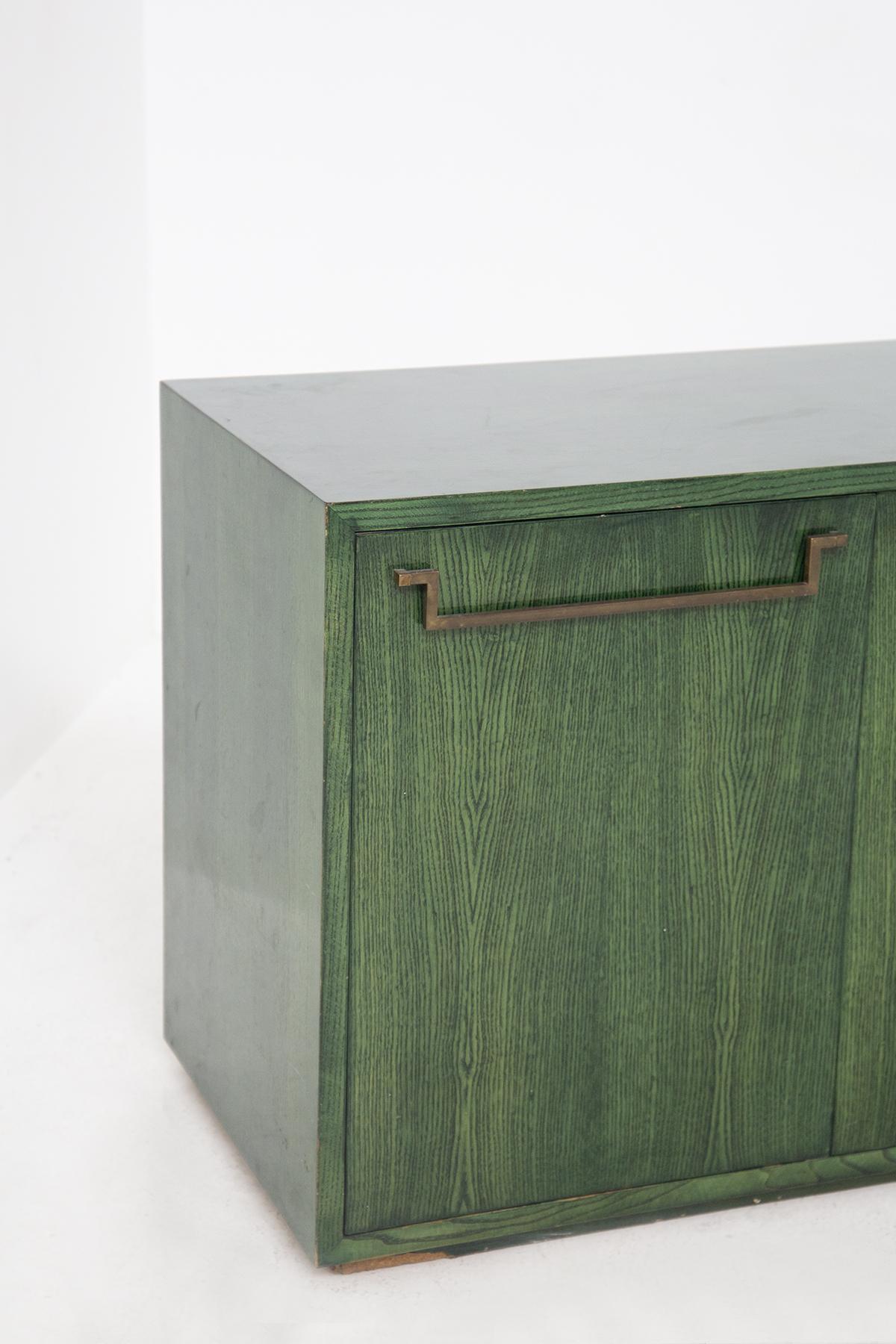 Gorgeous green painted wood sideboard by Vivai del Sud, fine Italian manufacture, from the 1970s.
The vintage sideboard is quite long with a rectangular shape and includes 4 front doors, of equal size. Each door is April through an elongated brass