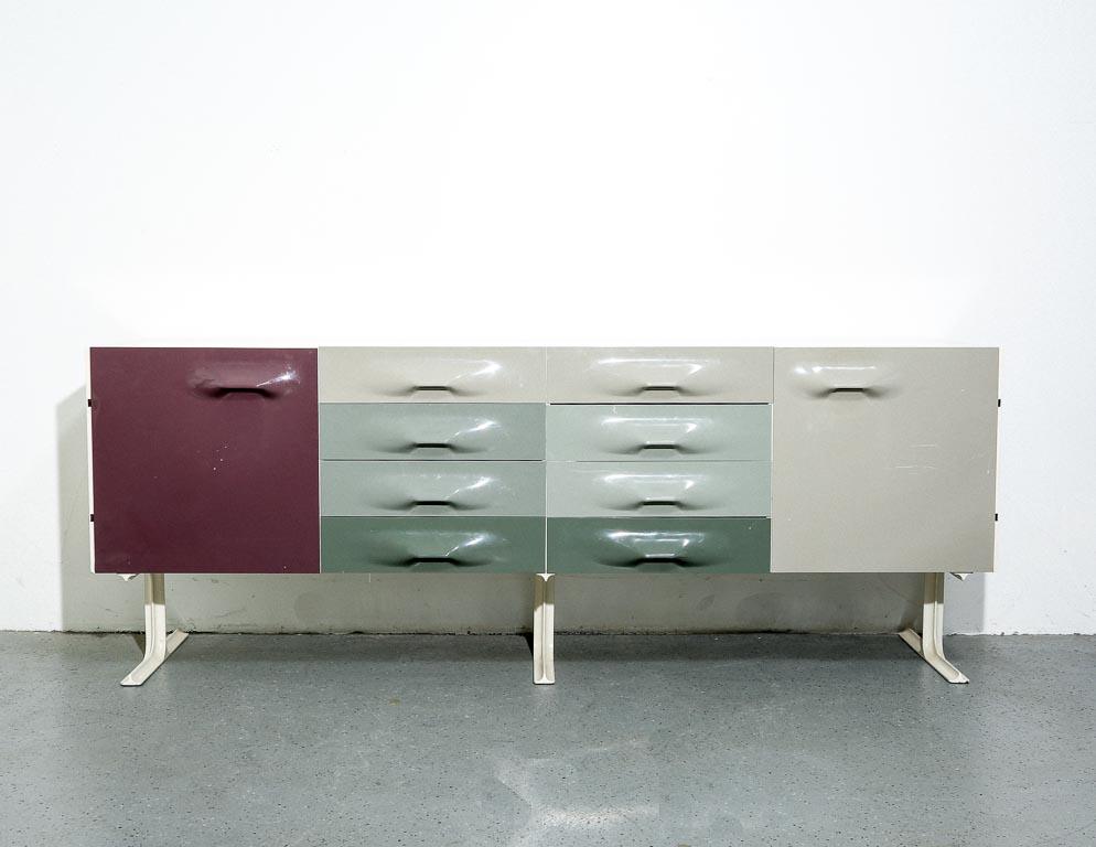 Vintage sideboard in the style of Raymond Loewy'd 'DF2000' series for CEI, France. White lacquered cabinetry with plastic doors and drawers over a white painted metal base. In shades of taupe, teal and gray.