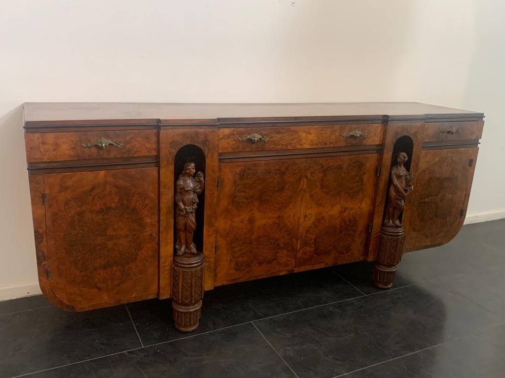 Ebanisteria Casalini Faenza.
Sideboard by Giovanni Guerrini for Ebanisteria Casalini (Faenza), 1930s. Walnut root structure and bronze hardware. On the front are two niches with female sculptures.

Packaging with bubble wrap and cardboard boxes is