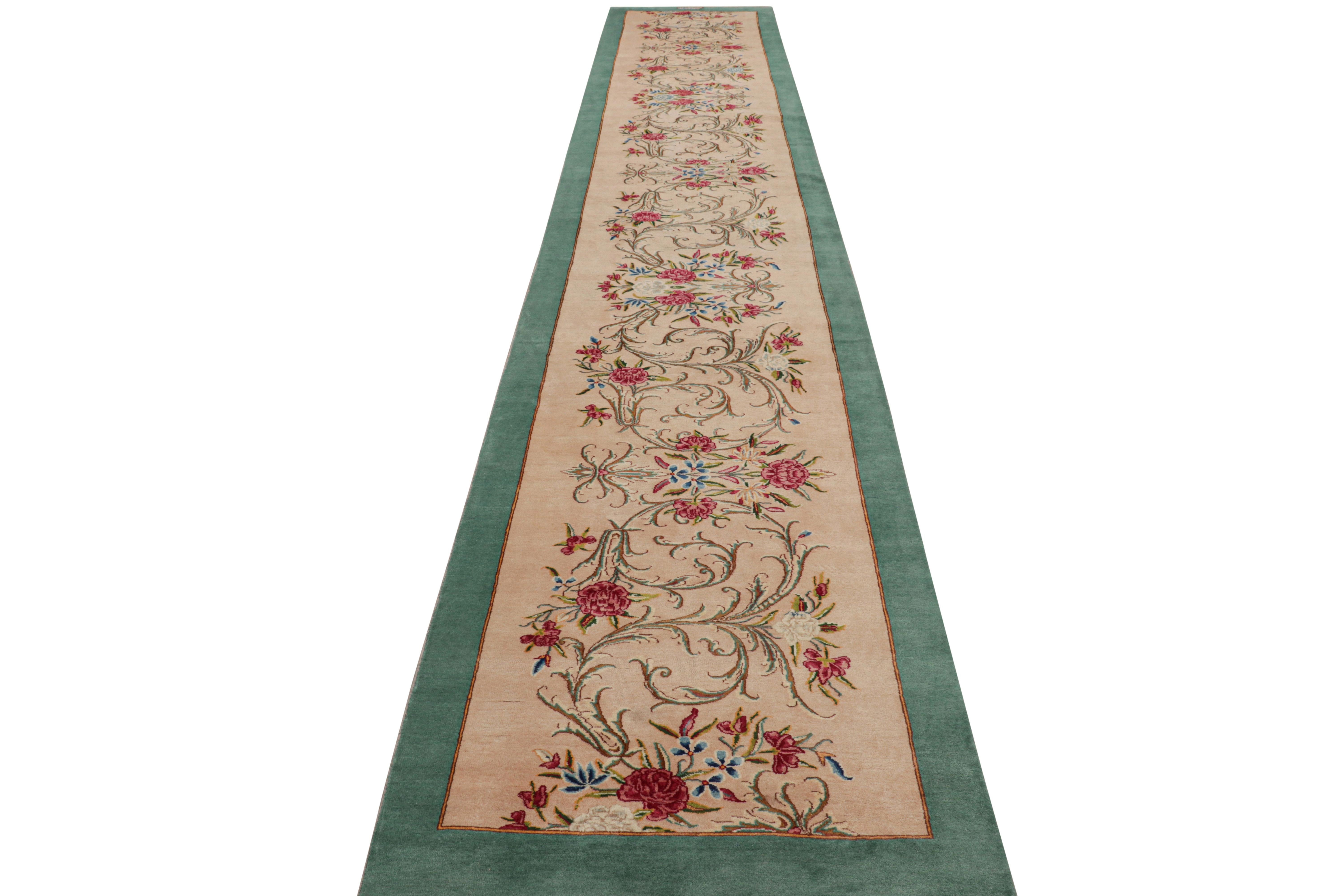 A pair of twin 3x21 vintage Persian runners, hand knotted in wool circa 1950-1960 from the acclaimed works of Rashid Farokhi. Among the rare few signature pieces, as seen in the upper border among hues of beige, red, and green. 

On the Design: