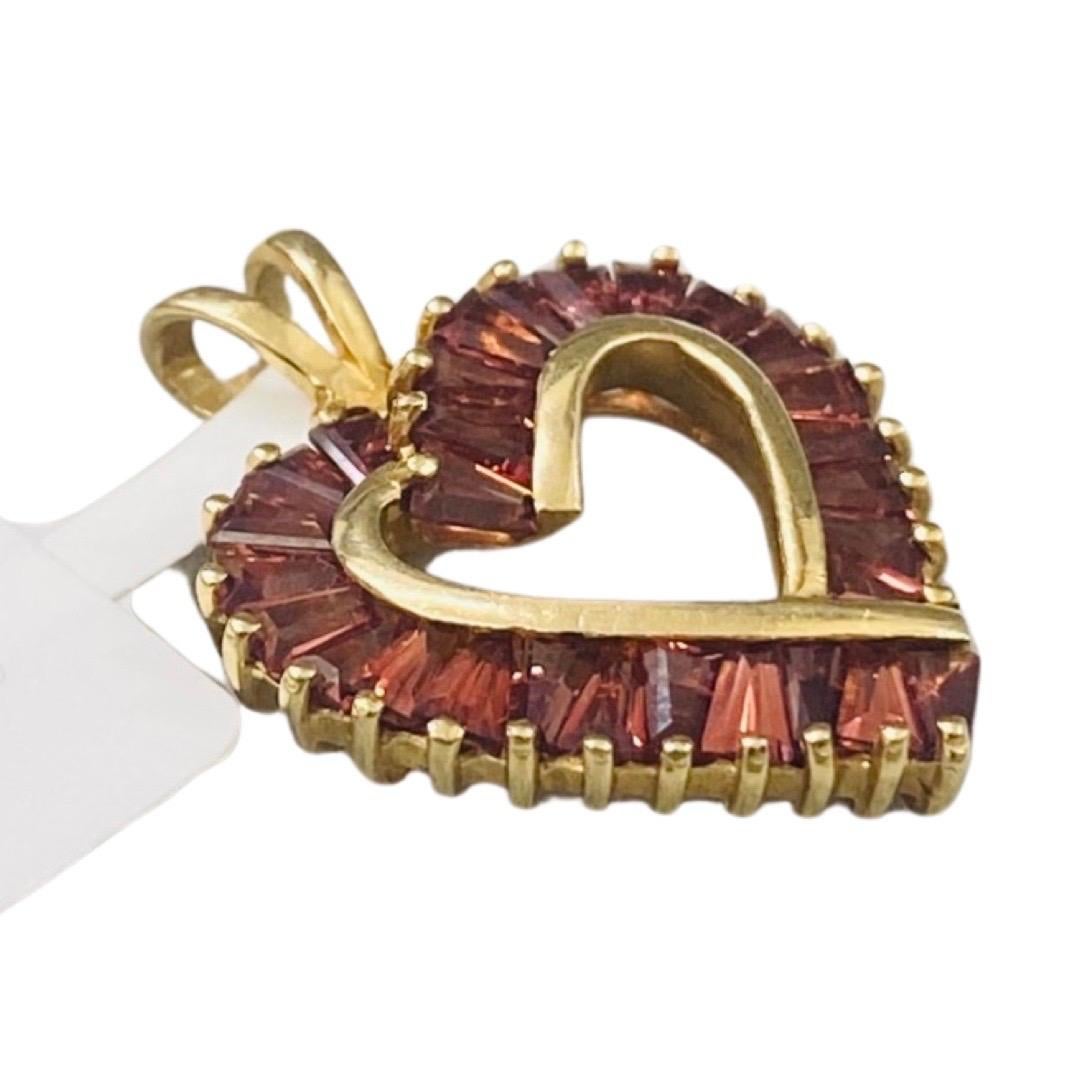 Vintage Signed 1.50 Carat Purple Pink Tourmaline Gemstone Heart Pendant 14k Gold. Very unique details with this beautiful designer heart pendant featuring all invisible channel setting tapered baguettes tourmaline gemstones to create a perfect