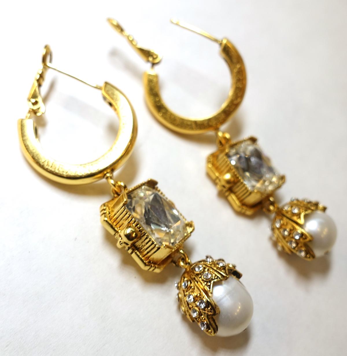 Everybody is looking for Alexander McQueen jewelry.  Here is one for you. These vintage signed Alexander McQueen earrings are designed with faux pearls with clear crystals accents in a gold tone setting.  These pierced earrings measure 2-1/4” x 3/4”