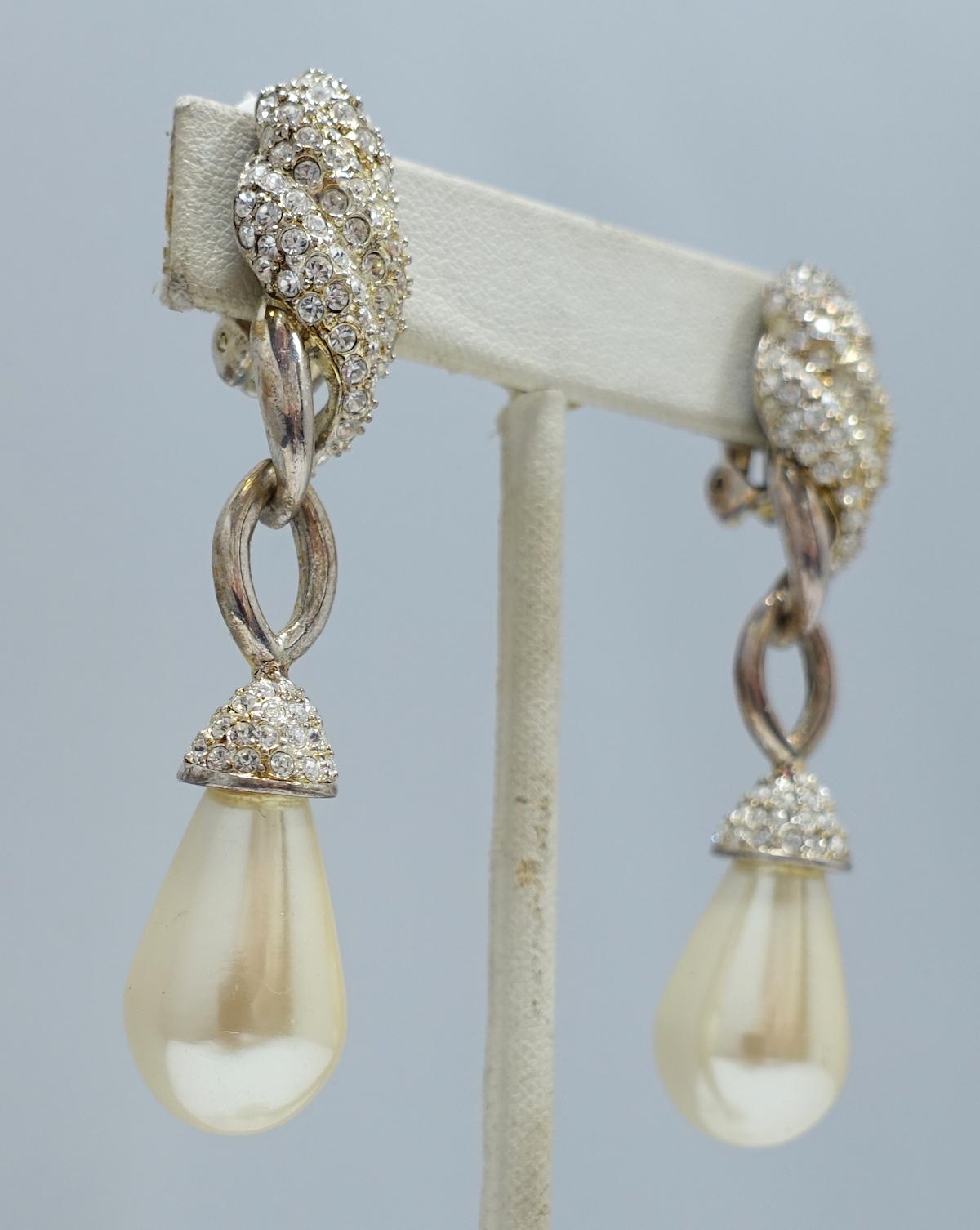 These vintage signed Carre earrings has a teardrop faux pearl with clear crystal accents in a silver tone setting.  In excellent condition, these clip earrings measure 2-3/4” x 5/8” and are signed “Carre”.