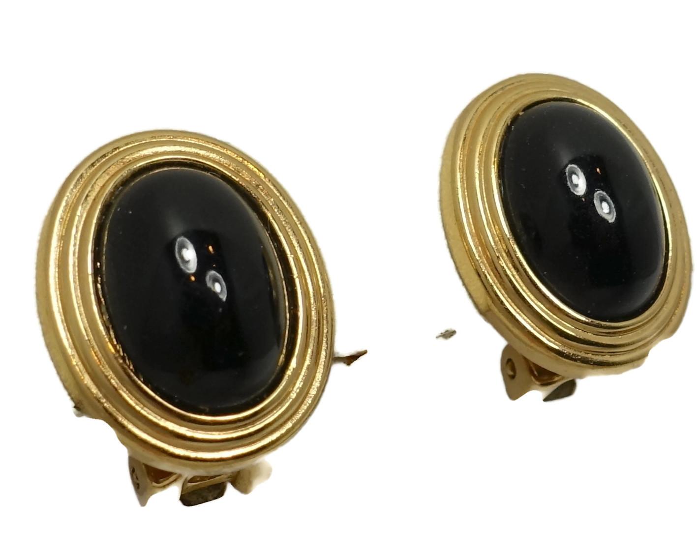 These vintage signed Christian Dior earrings feature black cabochon stones in a gold tone setting.  In excellent condition, these clip earrings measure 3/4” x 5/8” and are signed “Chr.Dior”.