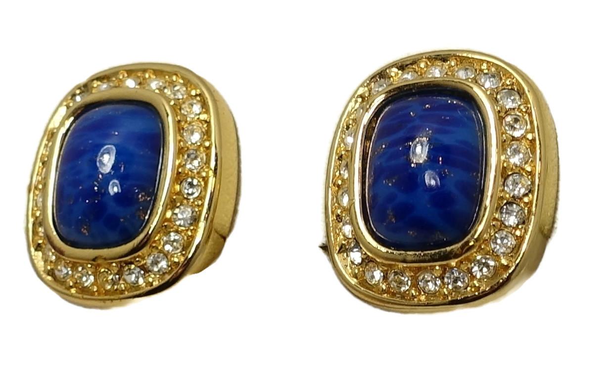 These vintage signed Christian Dior earrings feature faux lapis center stones with clear crystal accents in a gold tone setting.  In excellent condition, these clip earrings measure 5/8” x 1/2” and are signed “Chr. Dior”.