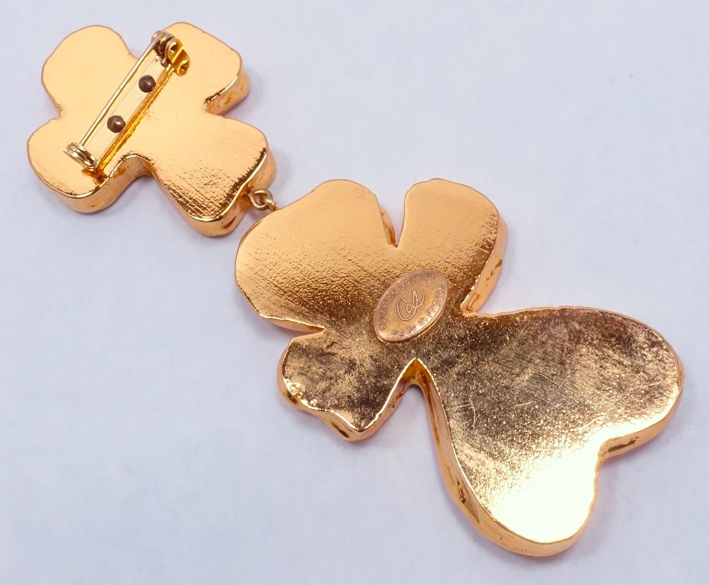 This vintage signed Christian Lacroix extremely long brooch features a dangling four leaf clover design.  In excellent condition, this brooch measures 4-1/2” x 1-3/4” and is signed “Christian LaCroix Made in France”.